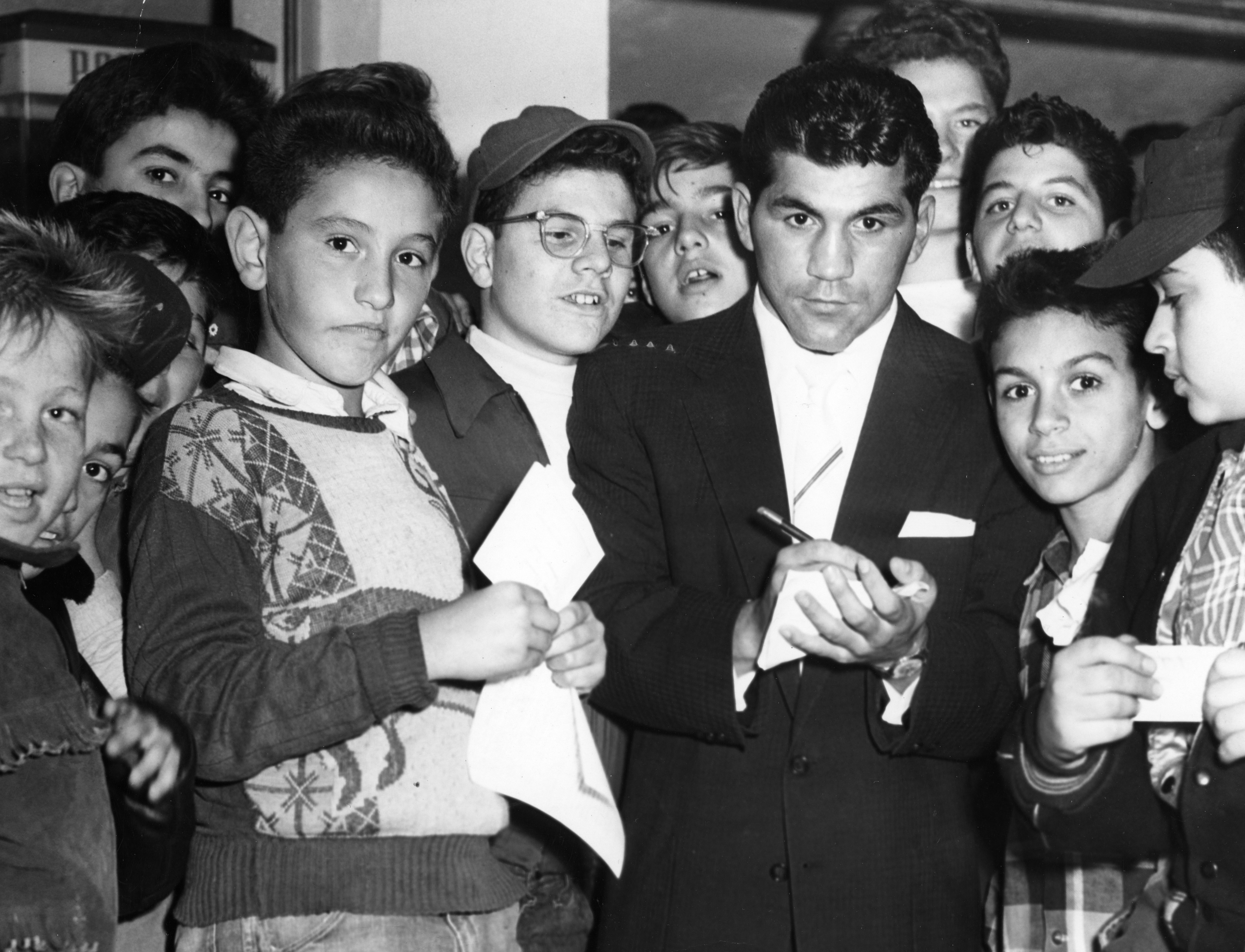 Mr. DeMarco, with a gang of fans, signing autographs in 1955.