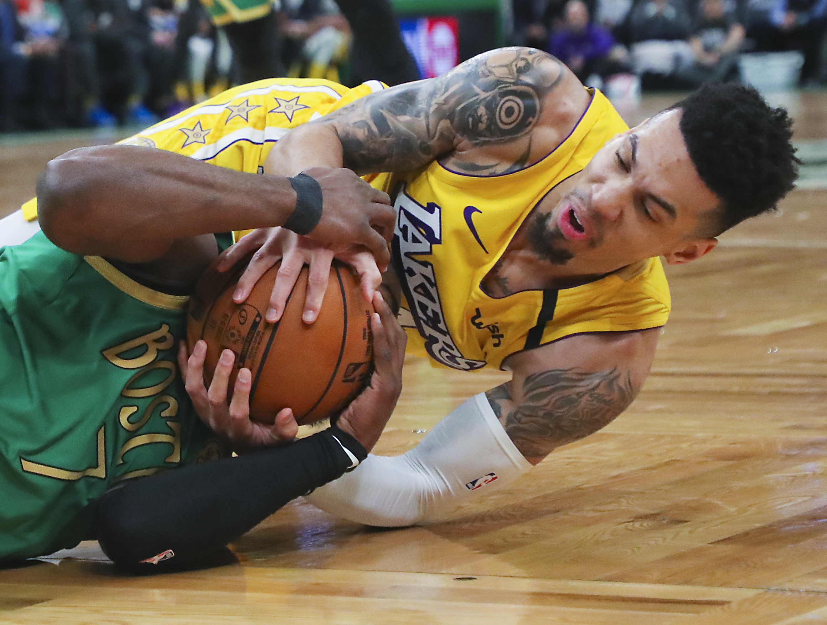 Celtics guard Jaylen Brown and Lakers guard Danny Green got tied up for a jump ball during the first quarter of Boston’s win January 20 over Los Angeles at TD Garden.