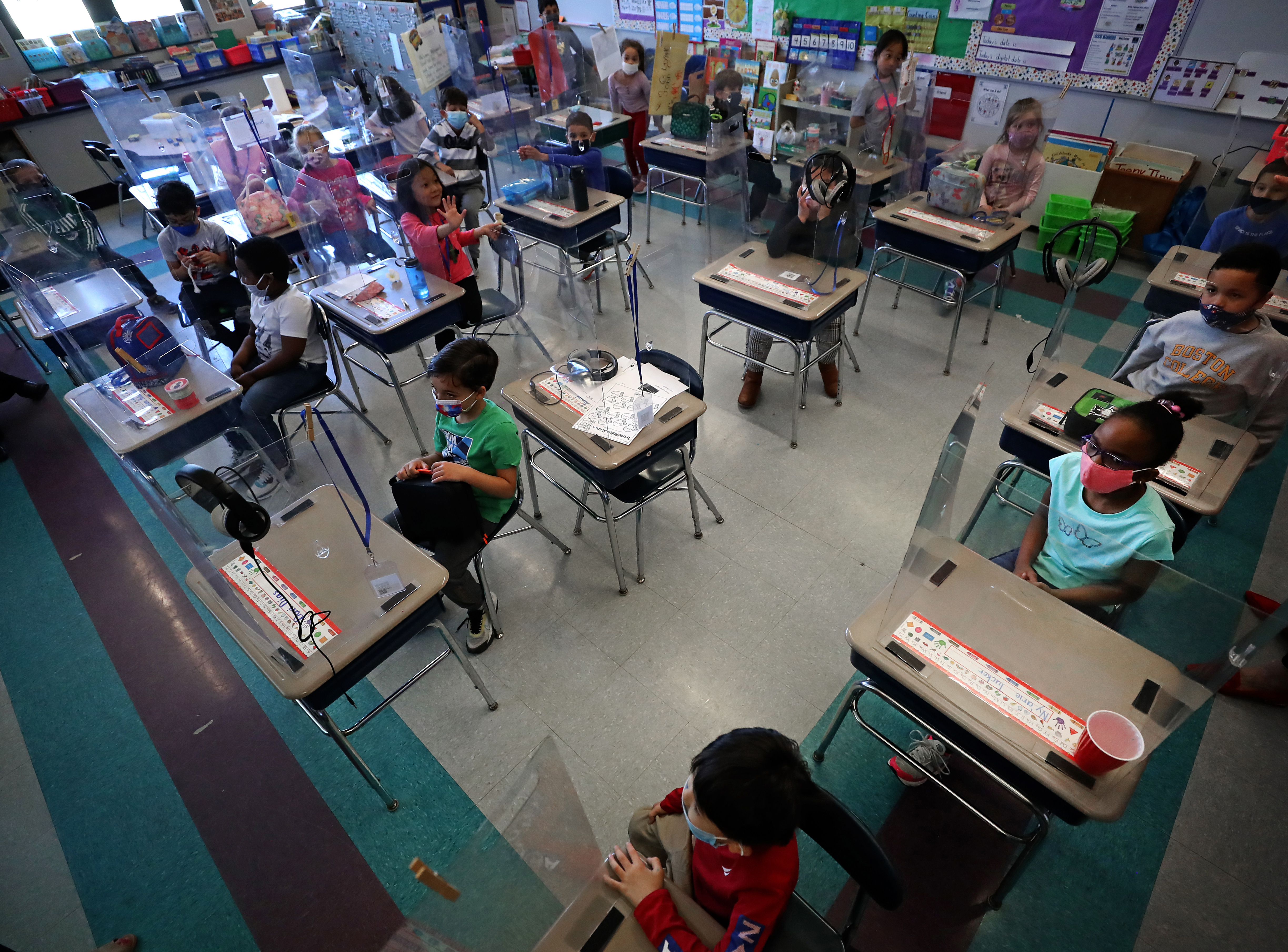 Susan Renaud's first-grade classroom uses protective plastic shields around the student's desks.