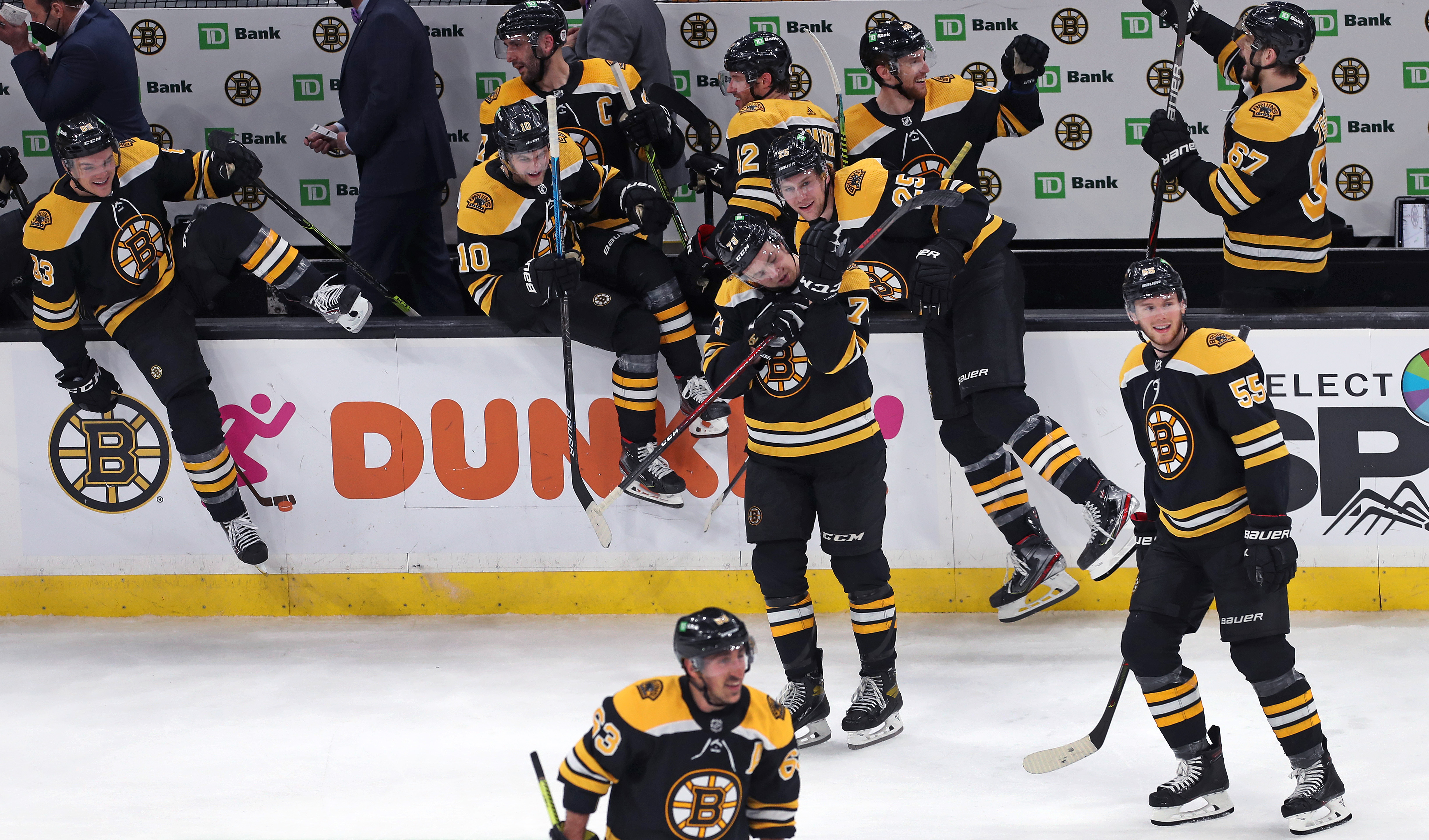 The Bruins celebrate at the end of Tuesday's shootout win over the Devils.