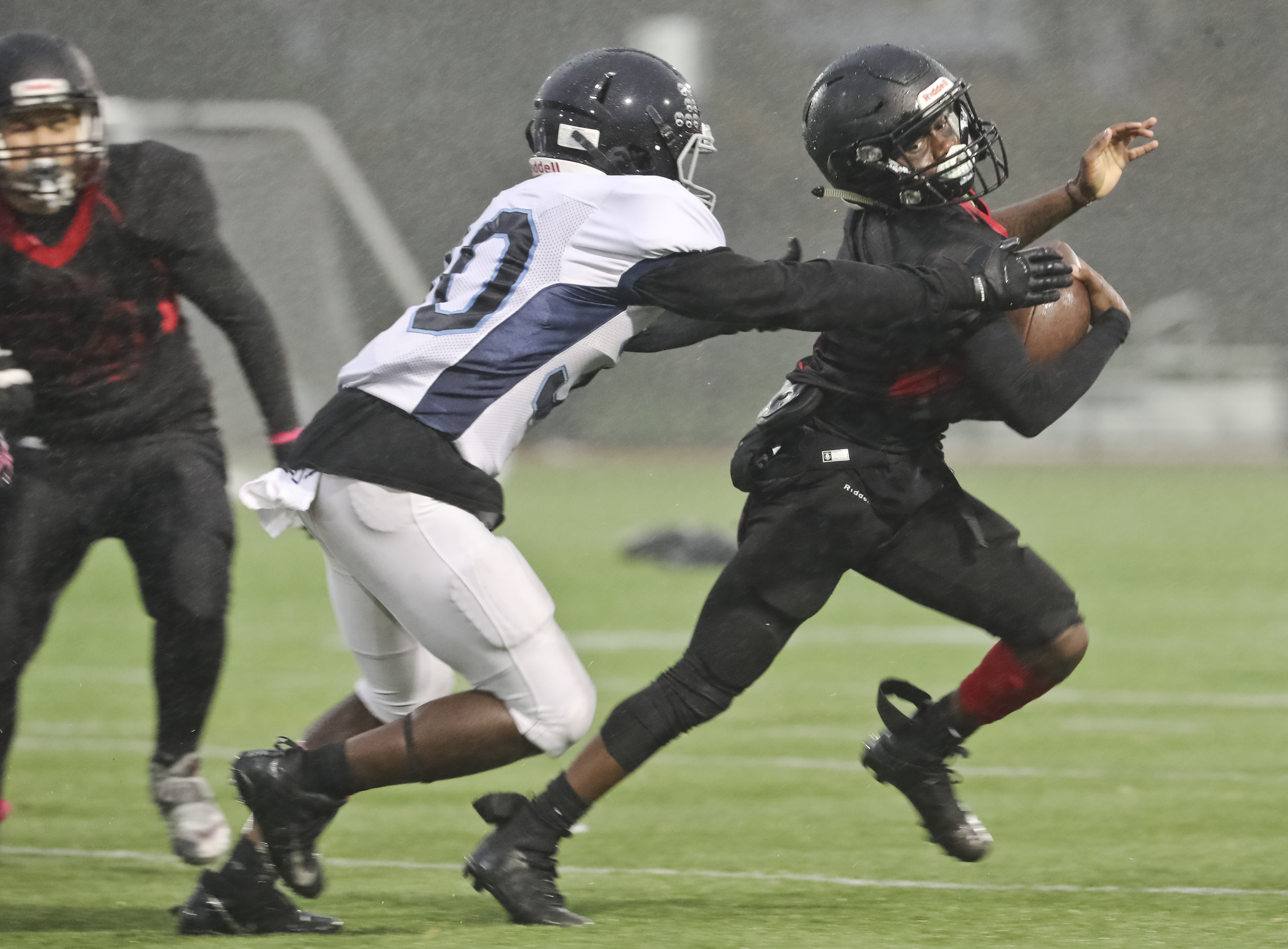 TechBoston quarterback Julius Gillard eludes Boston English/New Mission defender Luke McDonald in a game last season.