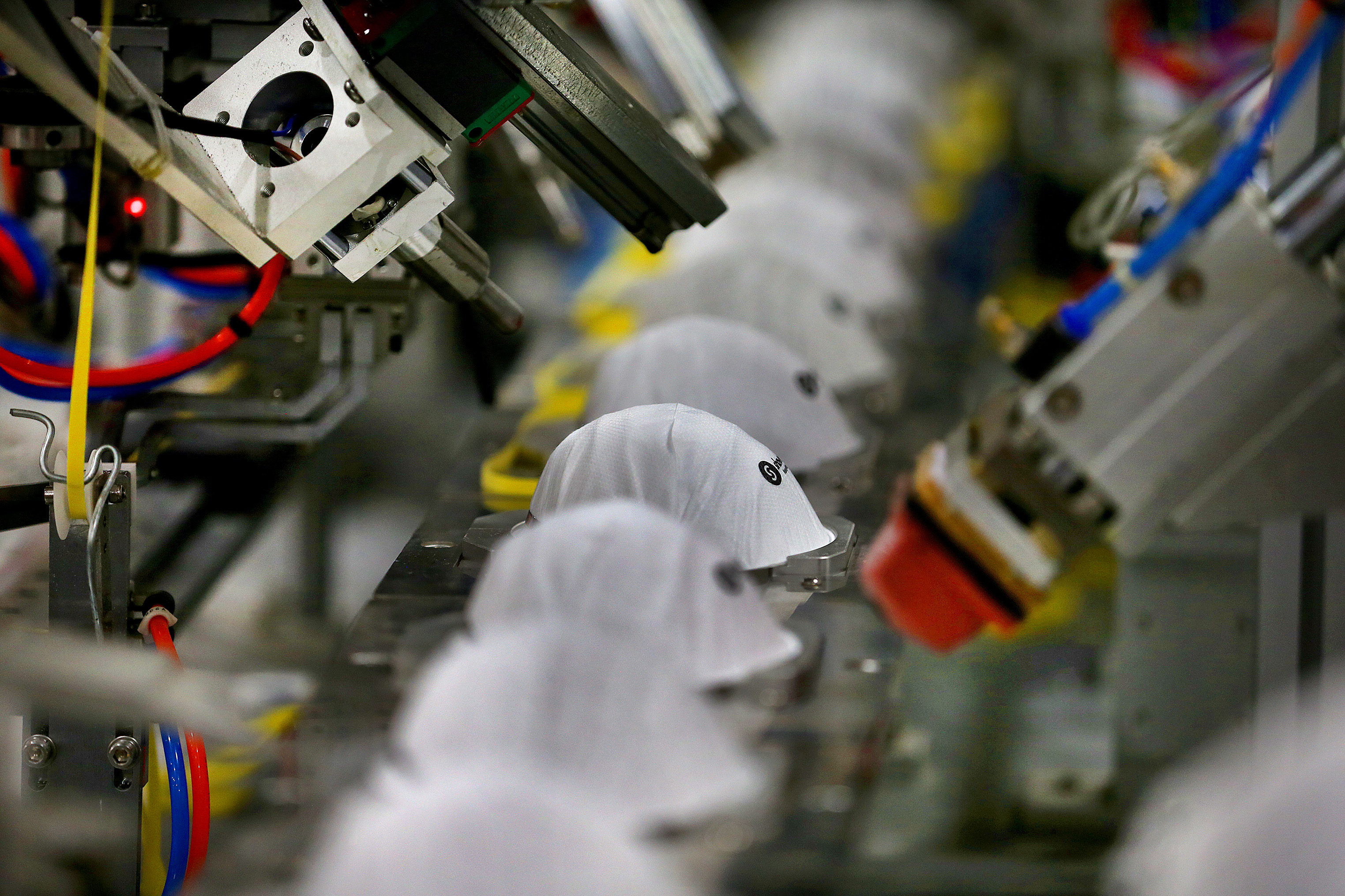 N95 masks traveled on an assembly line at the Shawmut Corporation manufacturing facility.