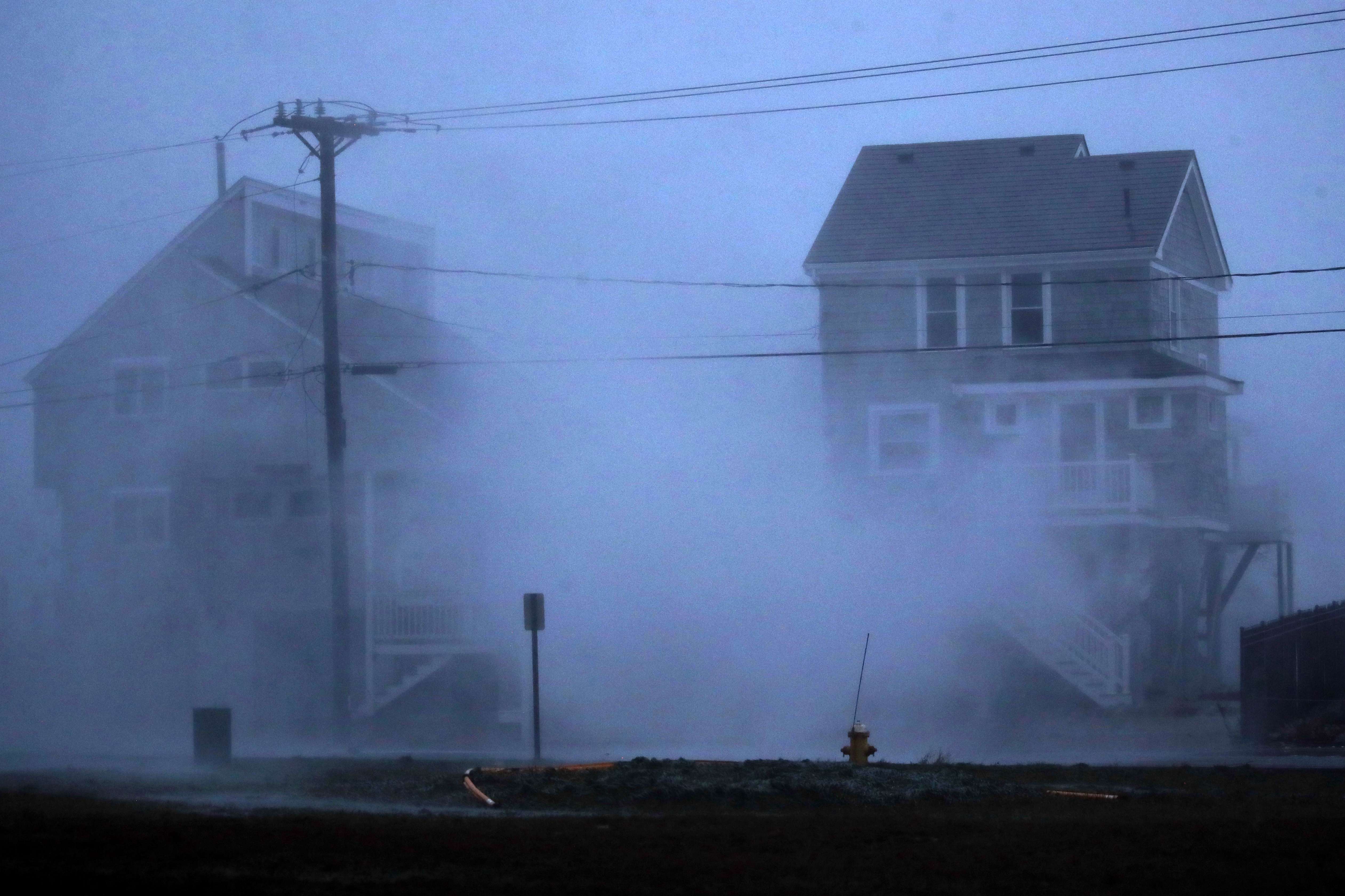 Waves crashed over the seawall at Brant Rock in Marshfield.