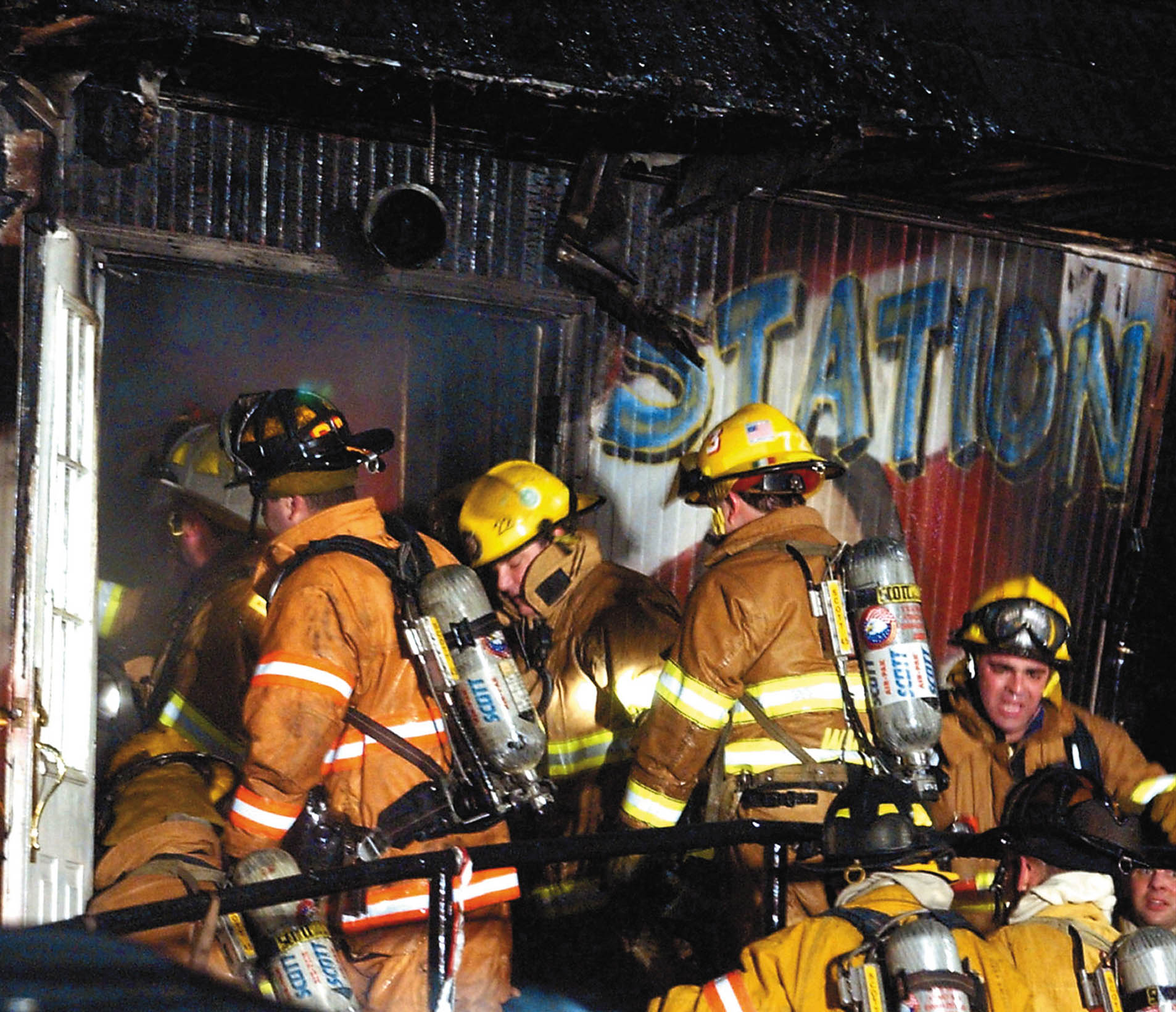 Firefighters crowd the charred front entrance of The Station nightclub early Friday, Feb. 21, 2003, looking for victims and trying to control the fire at the West Warwick, R.I., nightclub.