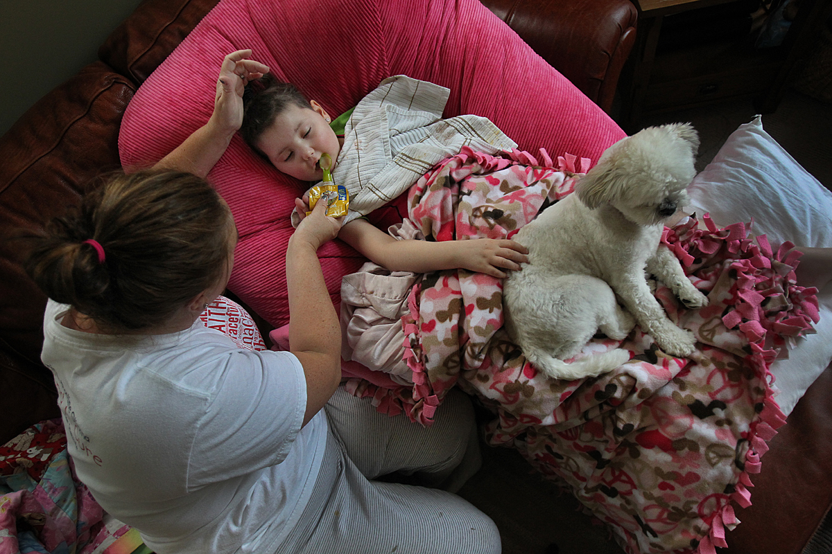 In July, Caroline could barely talk or move, and she wasn’t able to eat whole foods. There had been no miracle, and the drugs had not worked. Her beloved dog, Fluffy, was never far.