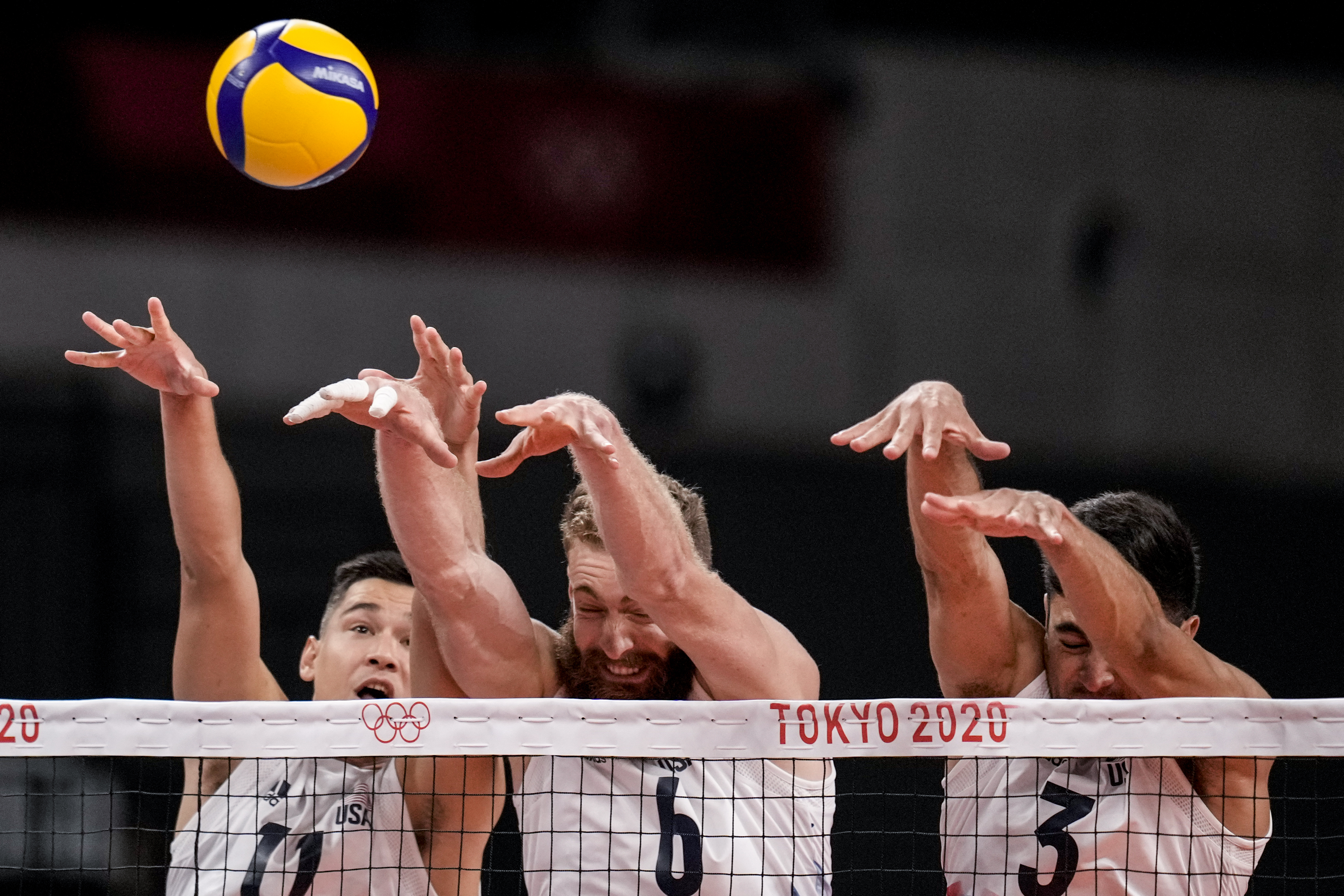 Despite the best efforts of (from left) Micah Christenson, Mitchel Stahl and Taylor Sander, Team USA dropped Friday's men's volleyball match to Brazil.