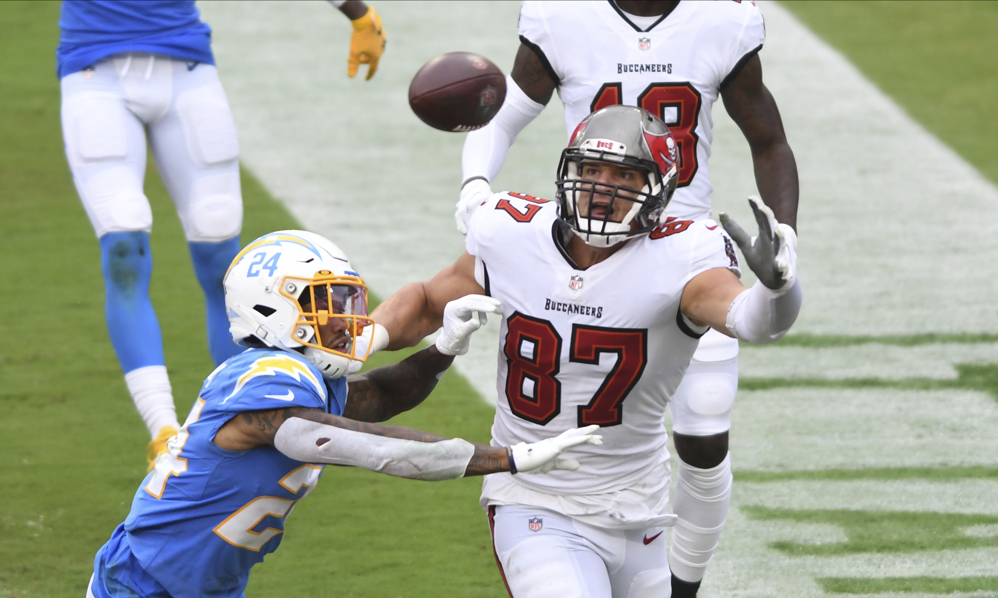 Tampa Bay tight end Rob Gronkowski goes for a pass against Los Angeles free safety Nasir Adderley during the first half of Sunday's game.