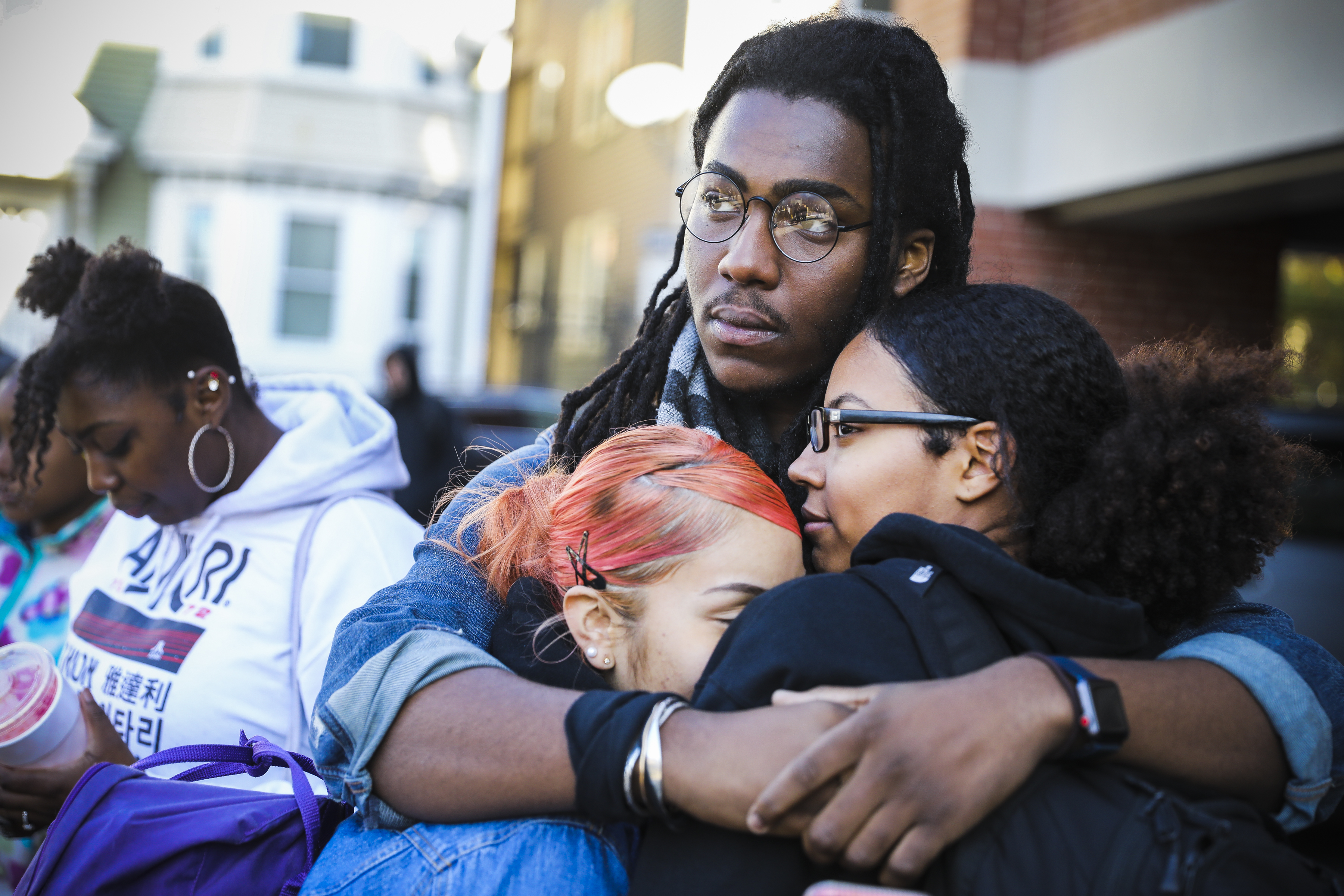 Alex Harris (center), a senior at Boston Collegiate Charter School, hugged Rosemary Martinez (left) and Katalina Cinelli during a walkout to protest racial unrest and discriminatory policies at the school.