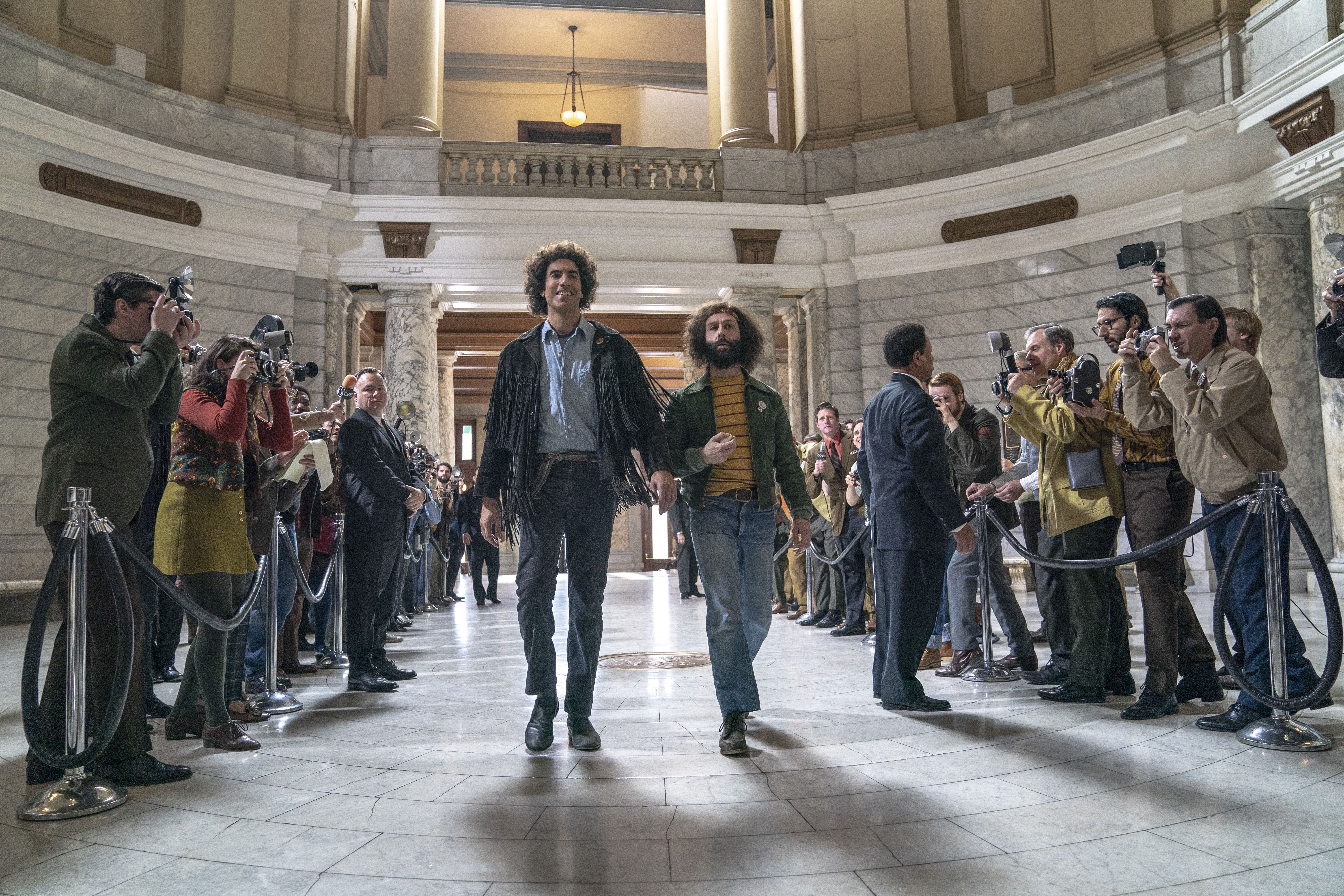Sacha Baron Cohen, center left, as Abbie Hoffman, and Jeremy Strong as Jerry Rubin in "The Trial of the Chicago 7."