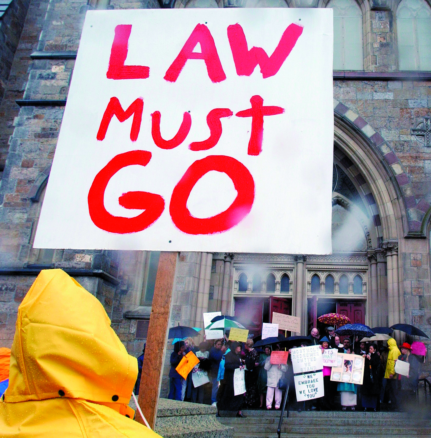 A man protesting against Cardinal Bernard Law faces a group of pro-Law protesters on the steps of the Cathedral of the Holy Cross in Boston, in April 2002.