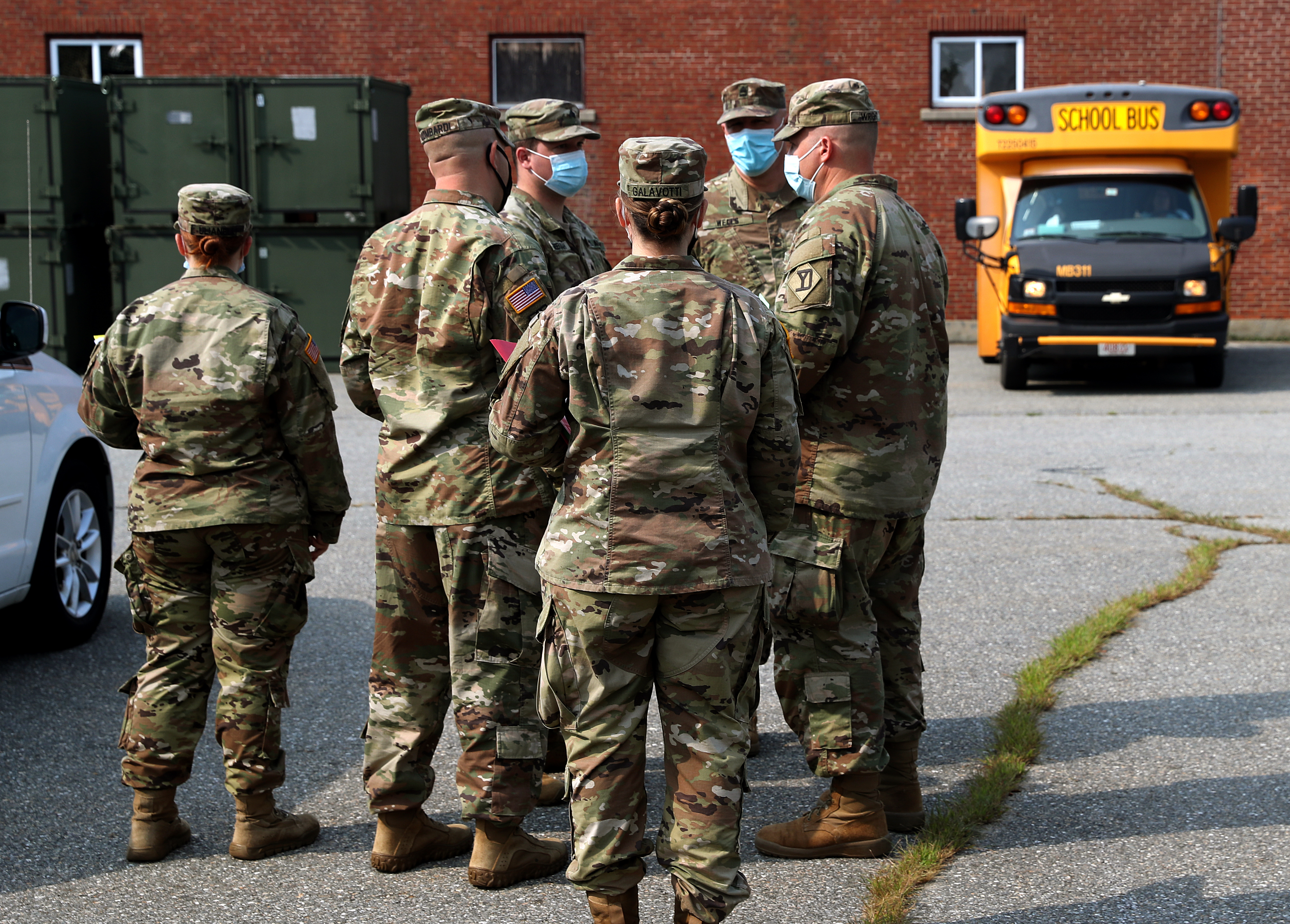Members of the National Guard await instructions on school bus operations.