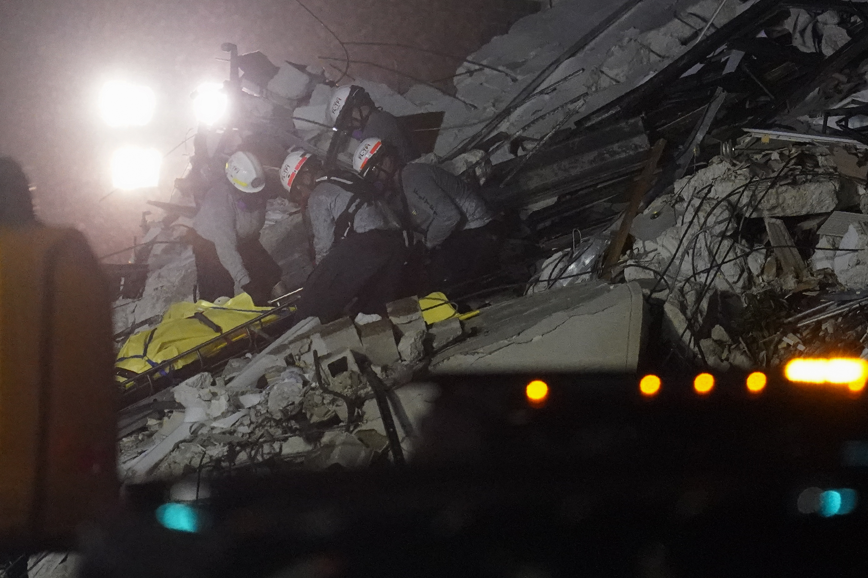 Rescue workers removed a body from the rubble on Thursday night.
