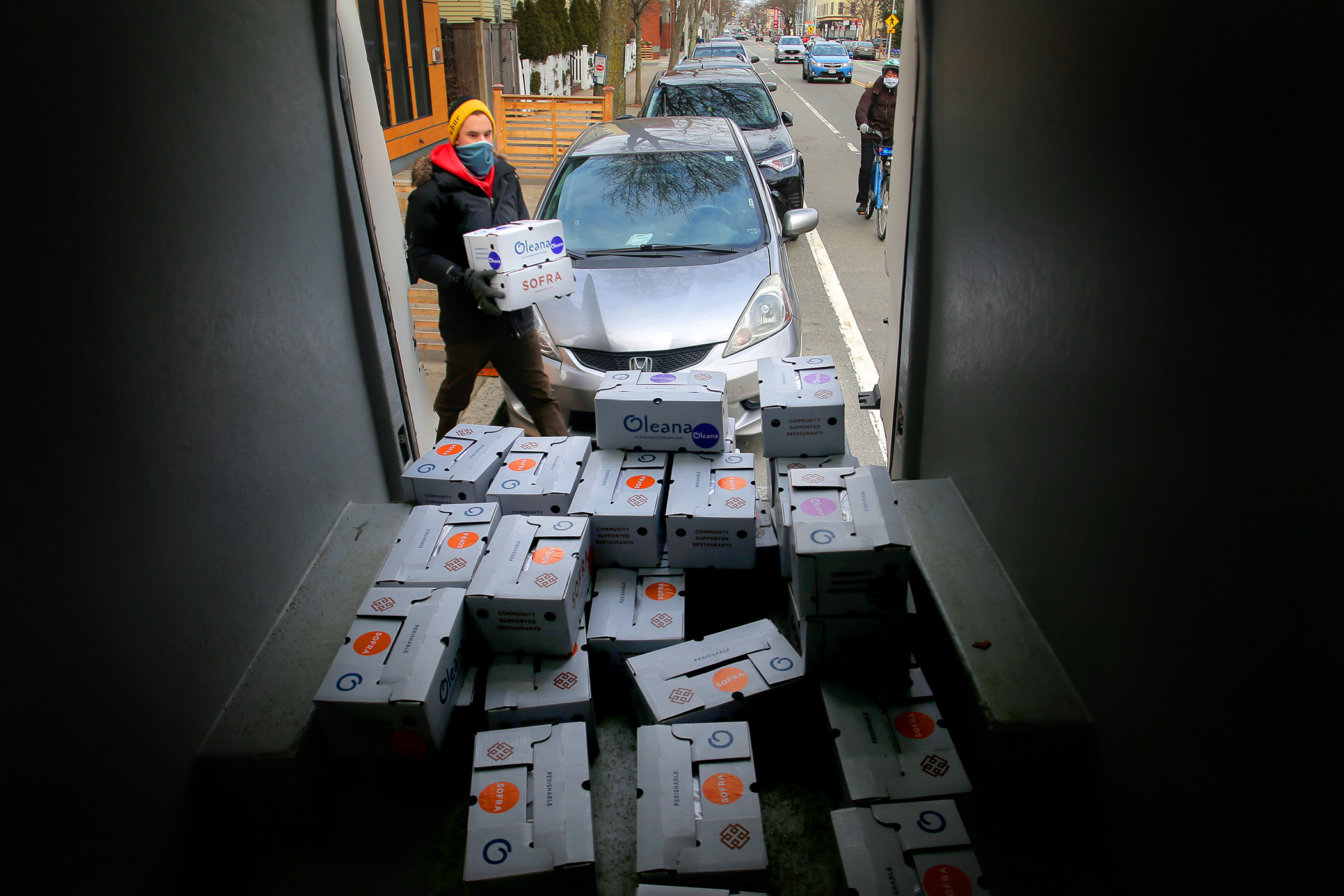 David Lubbock loads boxes into a truck for delivery. He works for What Cheer, a company handling the delivery for Oleana.