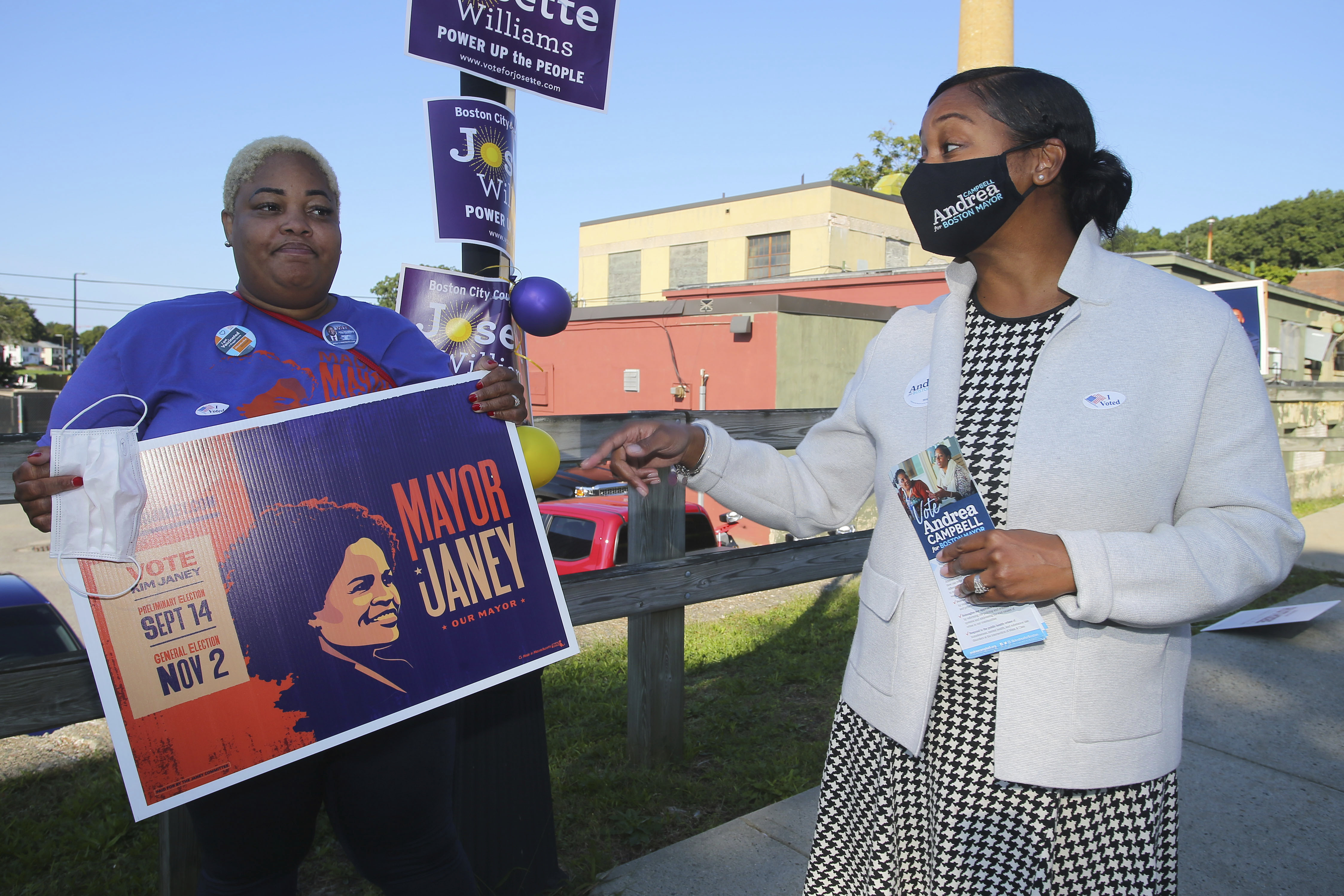 Boston mayoral candidate Andrea Campbell, right, talks with Aisha Miller, a supporter of Mayor Kim Janey, outside the Groveland Community Room in Boston, Tuesday, Sept. 14.