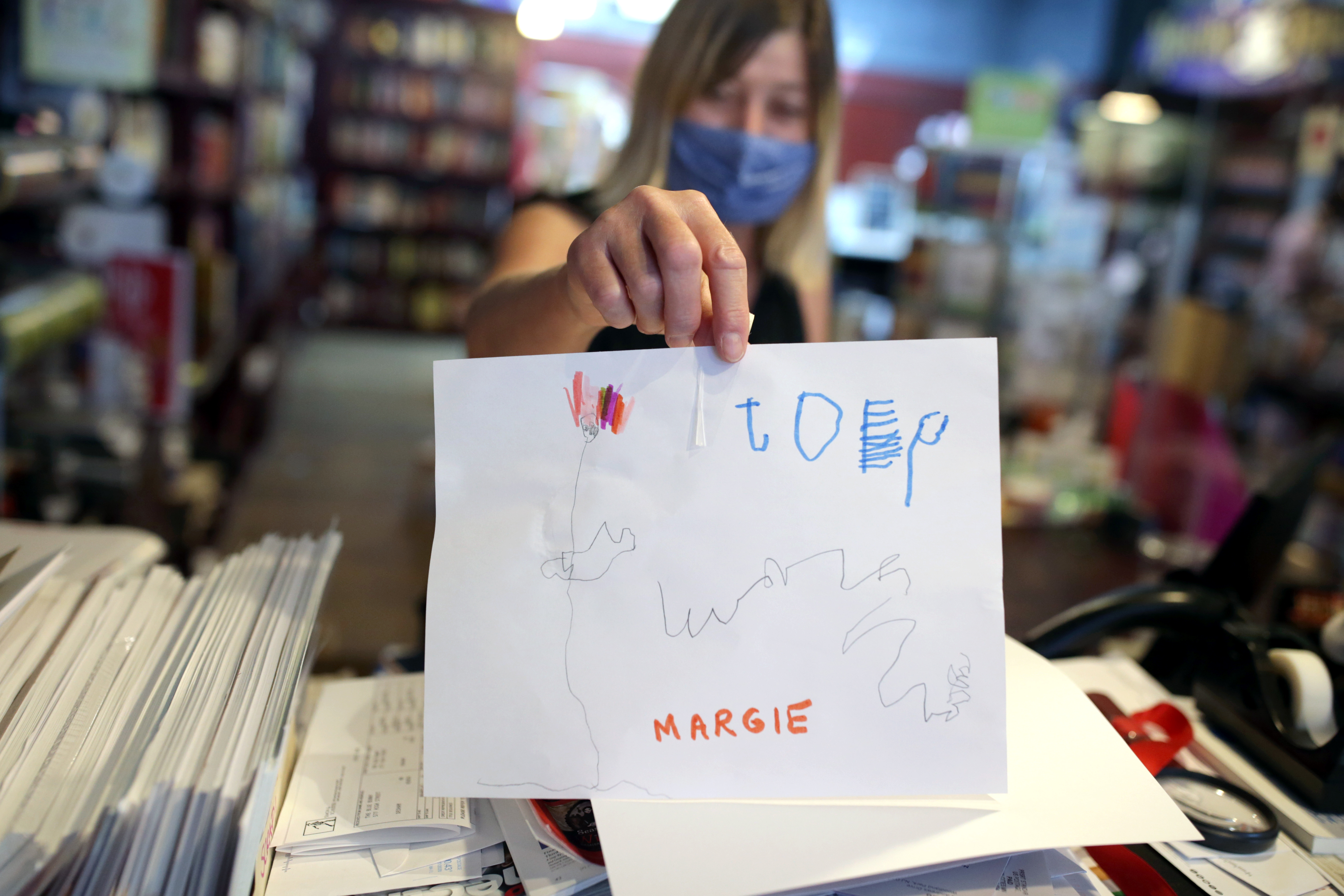 Margie Leonard, manager of The Blue Bunny, shows a drawing made by one of the children who visited the store recently.