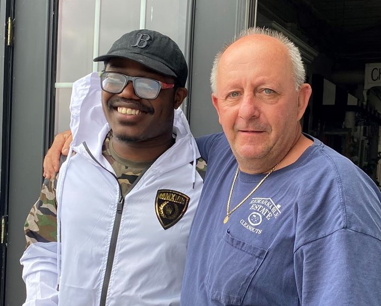 John Thomas Archer (left) poses with Mark Waters (right), owner of ReMARKable Cleanouts in Norwood. Archer went viral for a performance he gave on a piano at the shop Saturday and will take home the instrument as a gift.