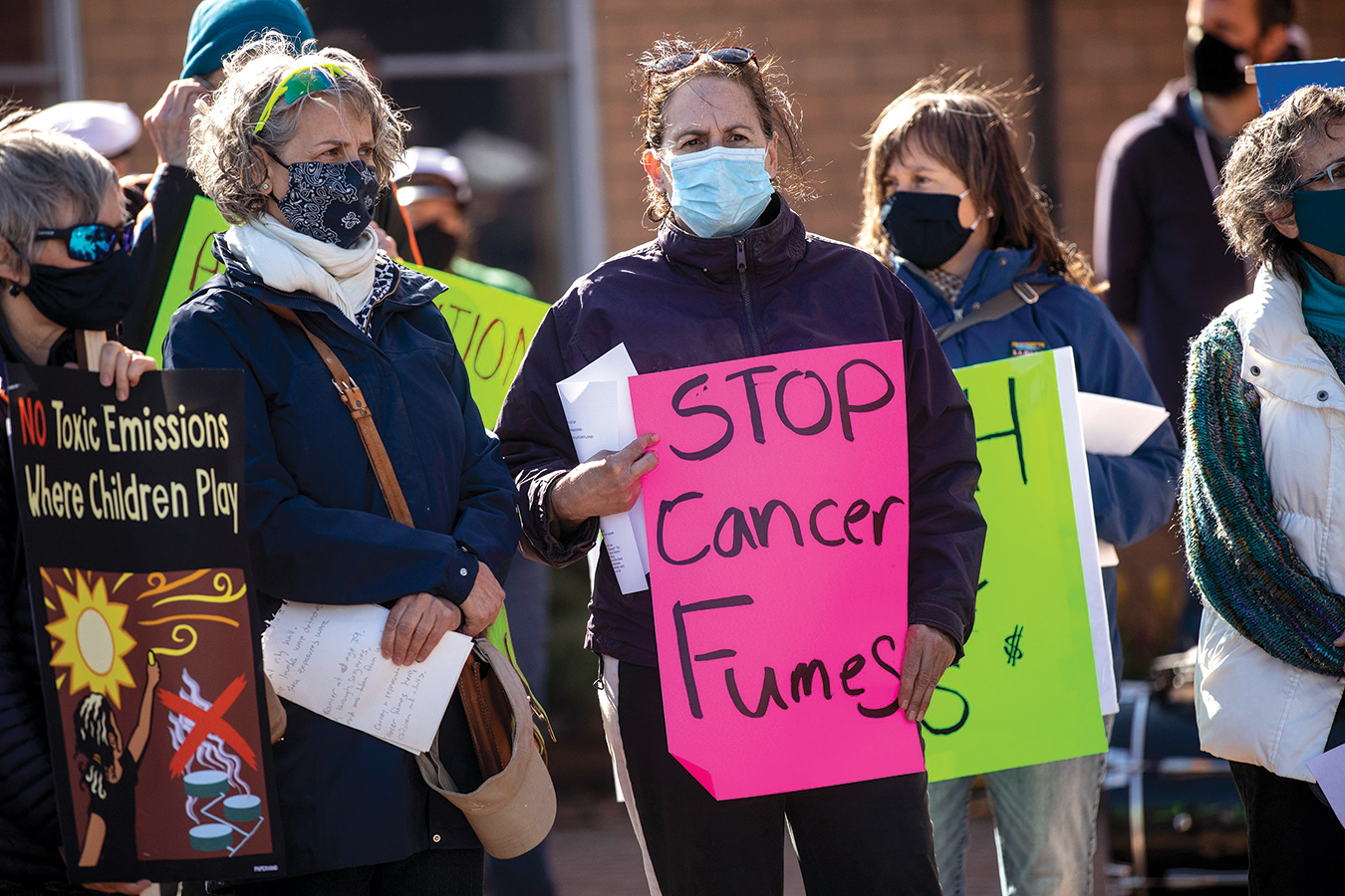 SOUTH PORTLAND, ME - APRIL 23: Carmen Haggerty, center, and PJ Cragin, left of Haggerty, attend a rally against petroleum tank emissions at Kaler Elementary School on Friday, April 23, 2021. Both women grew up in South Portland and Cragin spoke about how her sister died of cancer at the rally. HaggertyÕs daughter is on the track team at South Portland High School and told her mom they can sometimes smell the fumes from the tanks during practice. (Staff photo by Brianna Soukup/Staff Photographer)