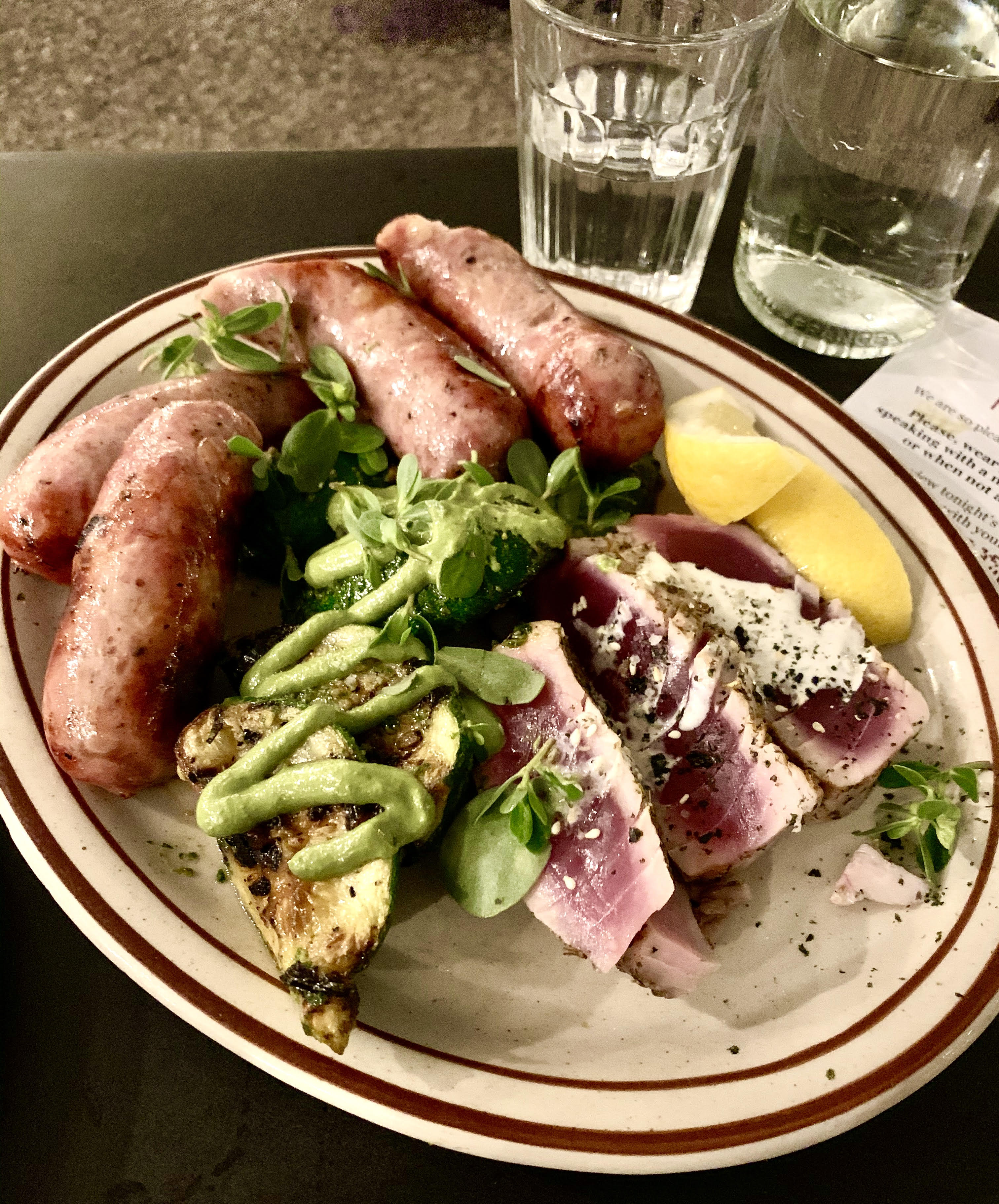 Craigie Next Door chef and owner Tony Maws recently prepared grilled yellowfin tuna and pork sausages, which were served with local summer squash drizzled with green tahini.