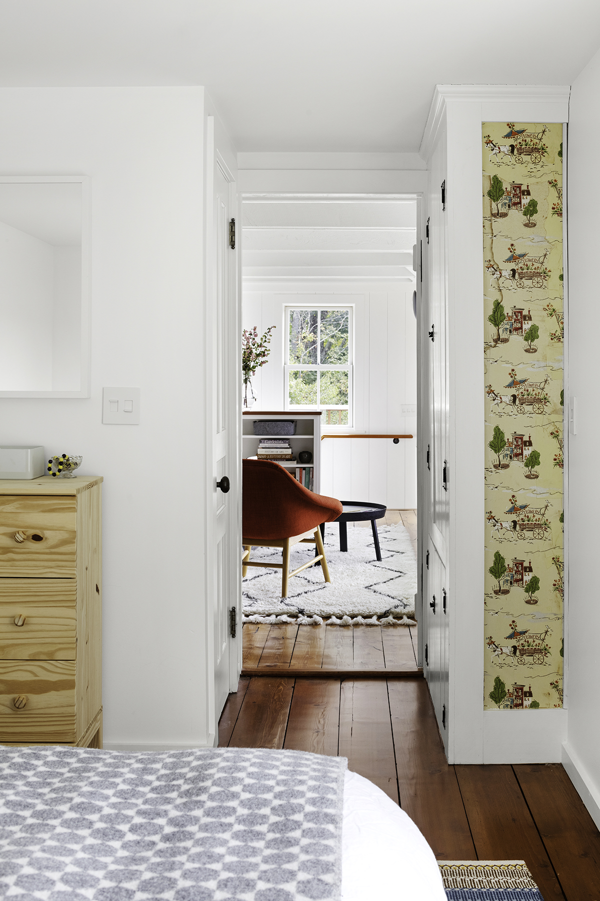 A strip of original wallpaper remains in the couple’s bedroom. “Preserving old materials lends charm,” Waters says.