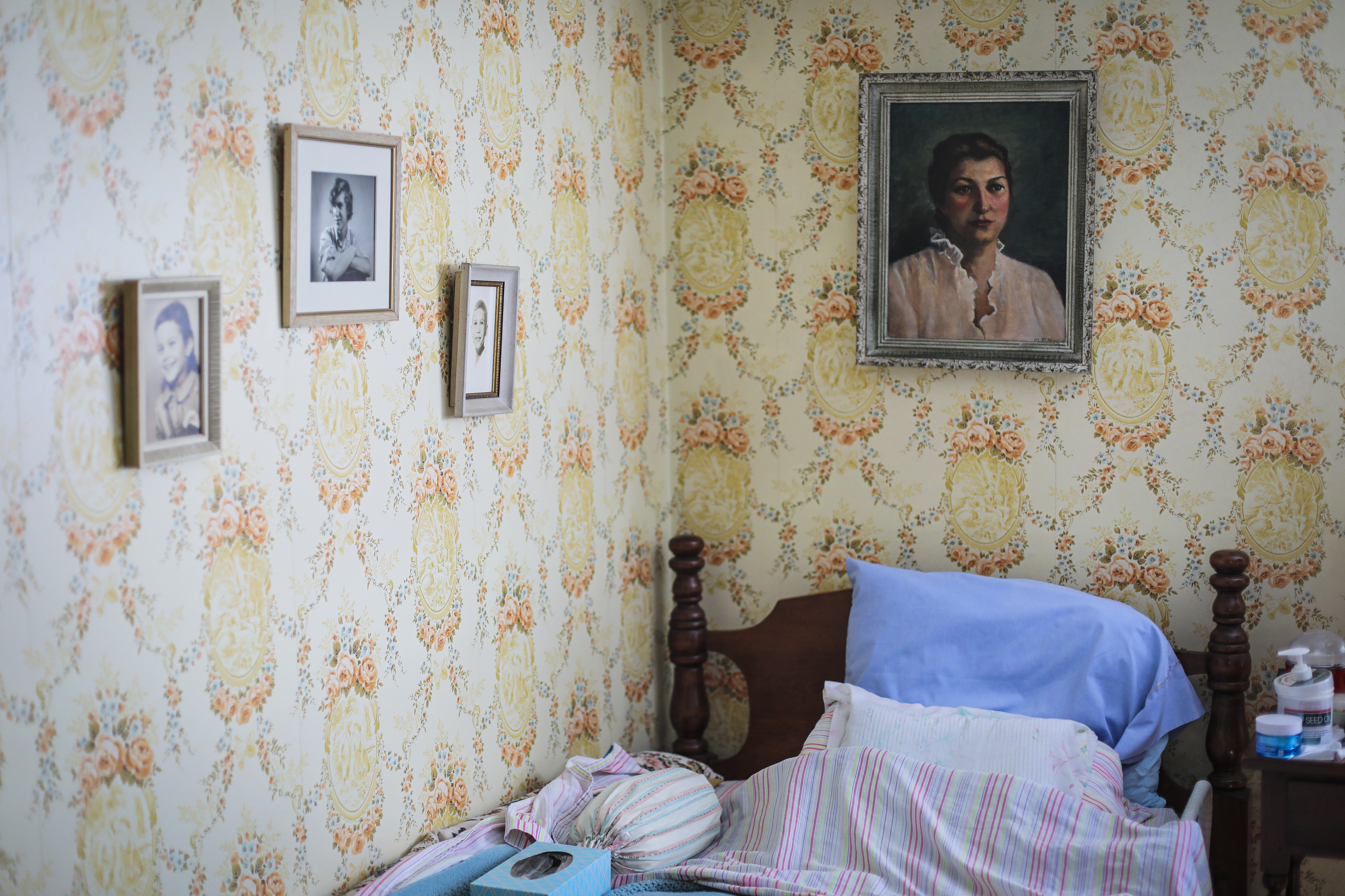 A painting of Juliet Bernstein hangs in the bedroom of her Chatham home, along with photos of her three children.