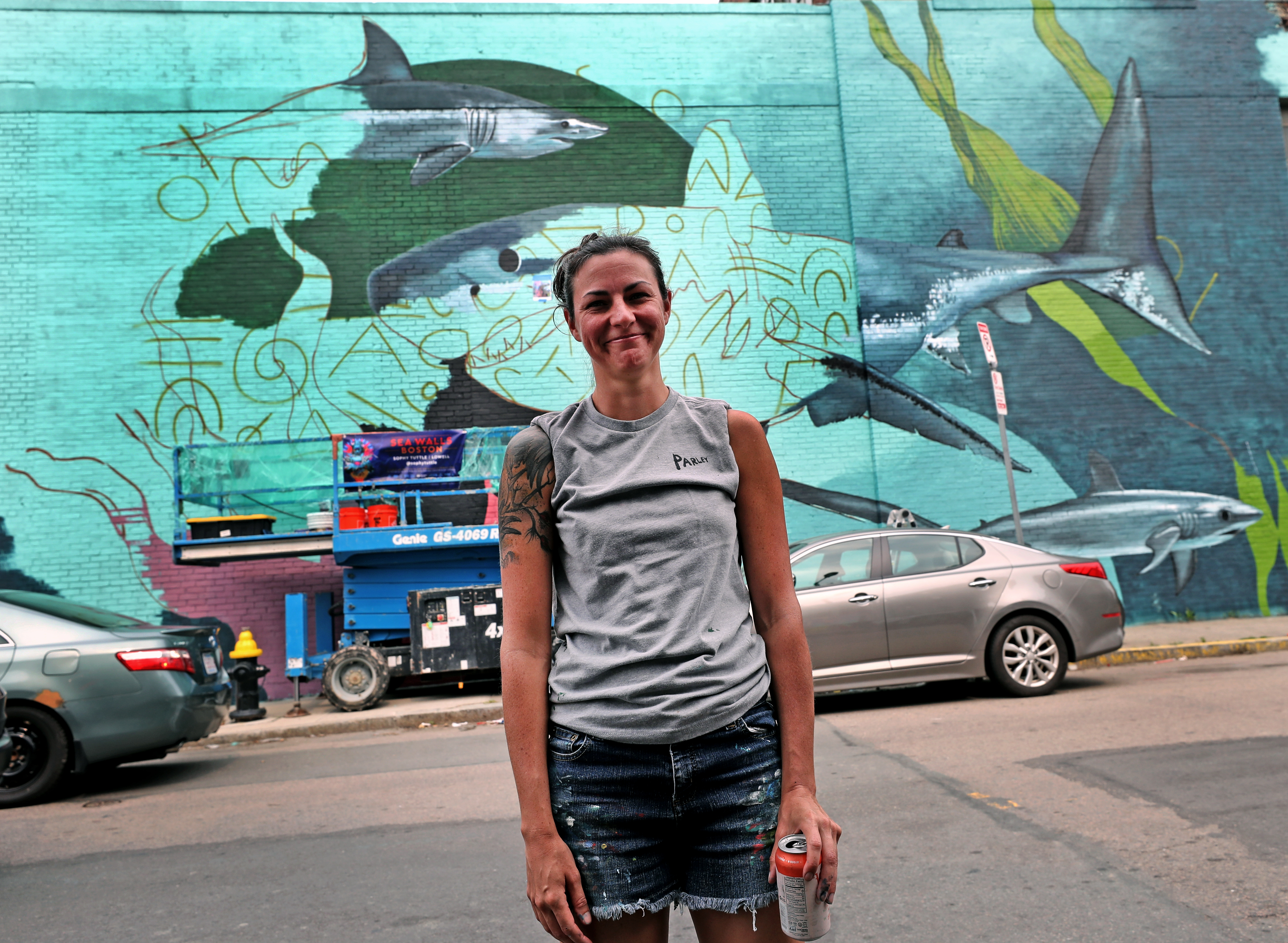 Sophy Tuttle took a break from painting her mural on Border Street.