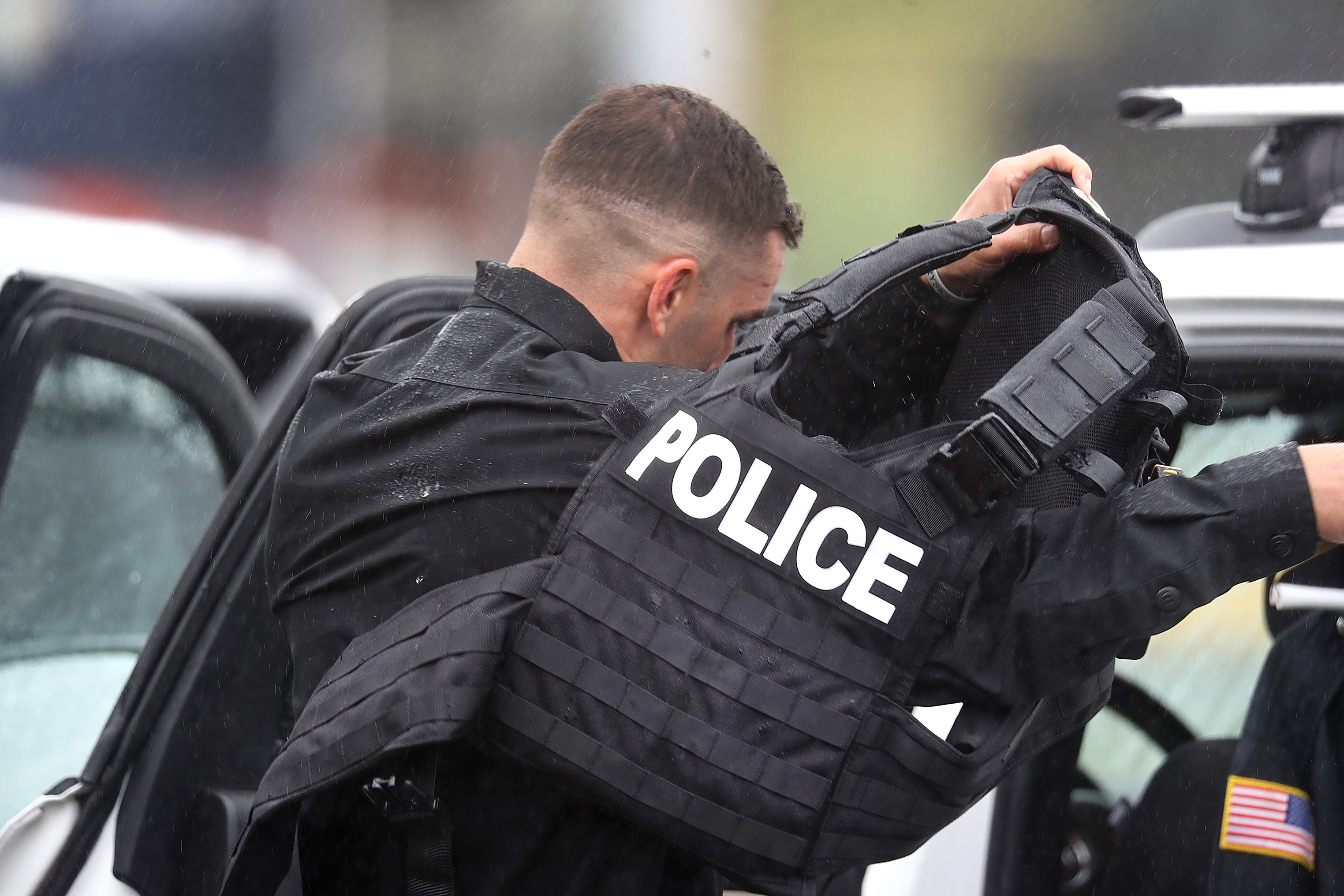 An officer removed his vest at the staging area.