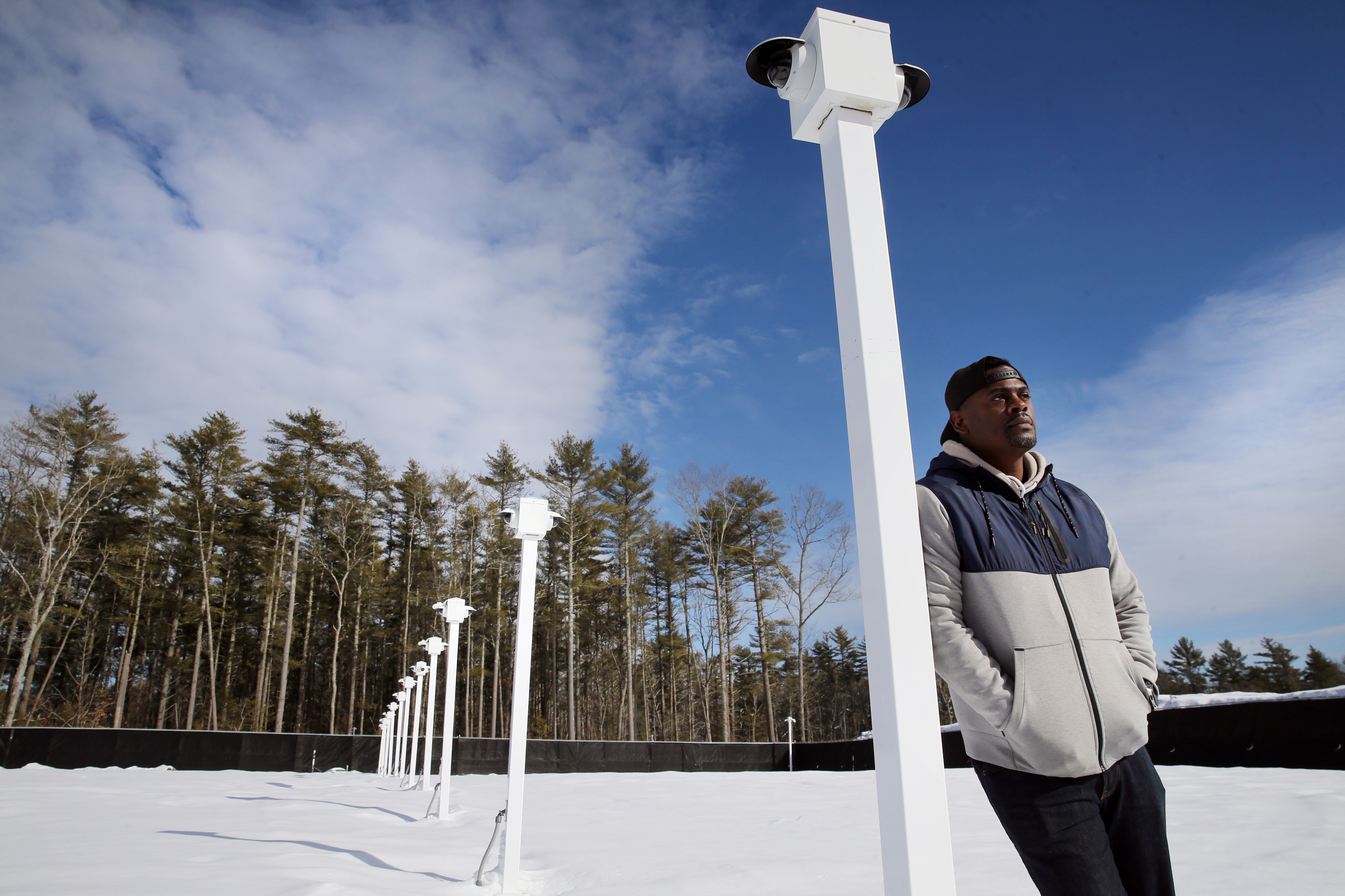Holistic Health Group cofounder Colonel Boothe stood under the security cameras that monitor his company's outdoor cannabis farm in Middleborough.