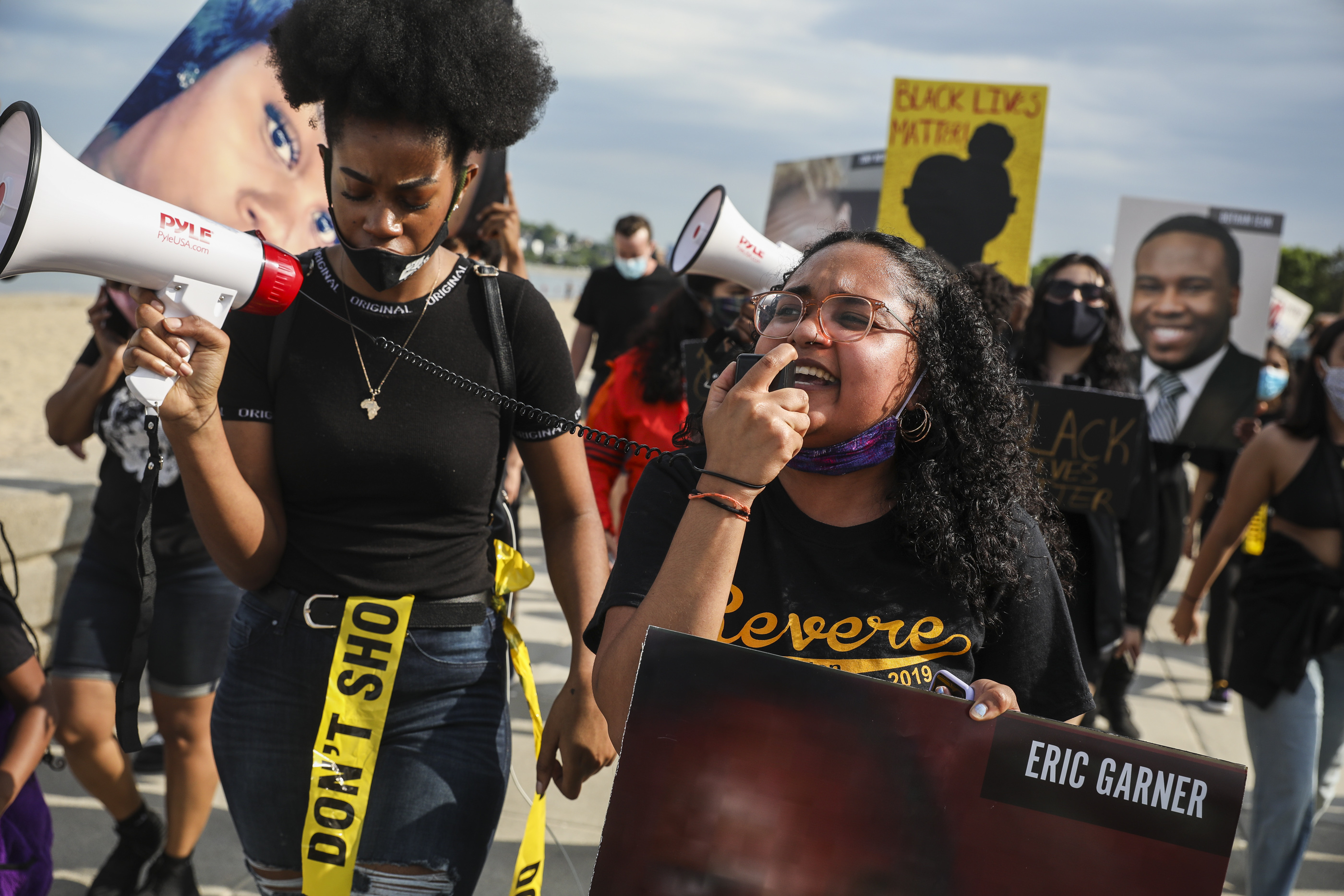 Organizer Savannah Hart led a chant while marching with hundreds who gathered in Revere.