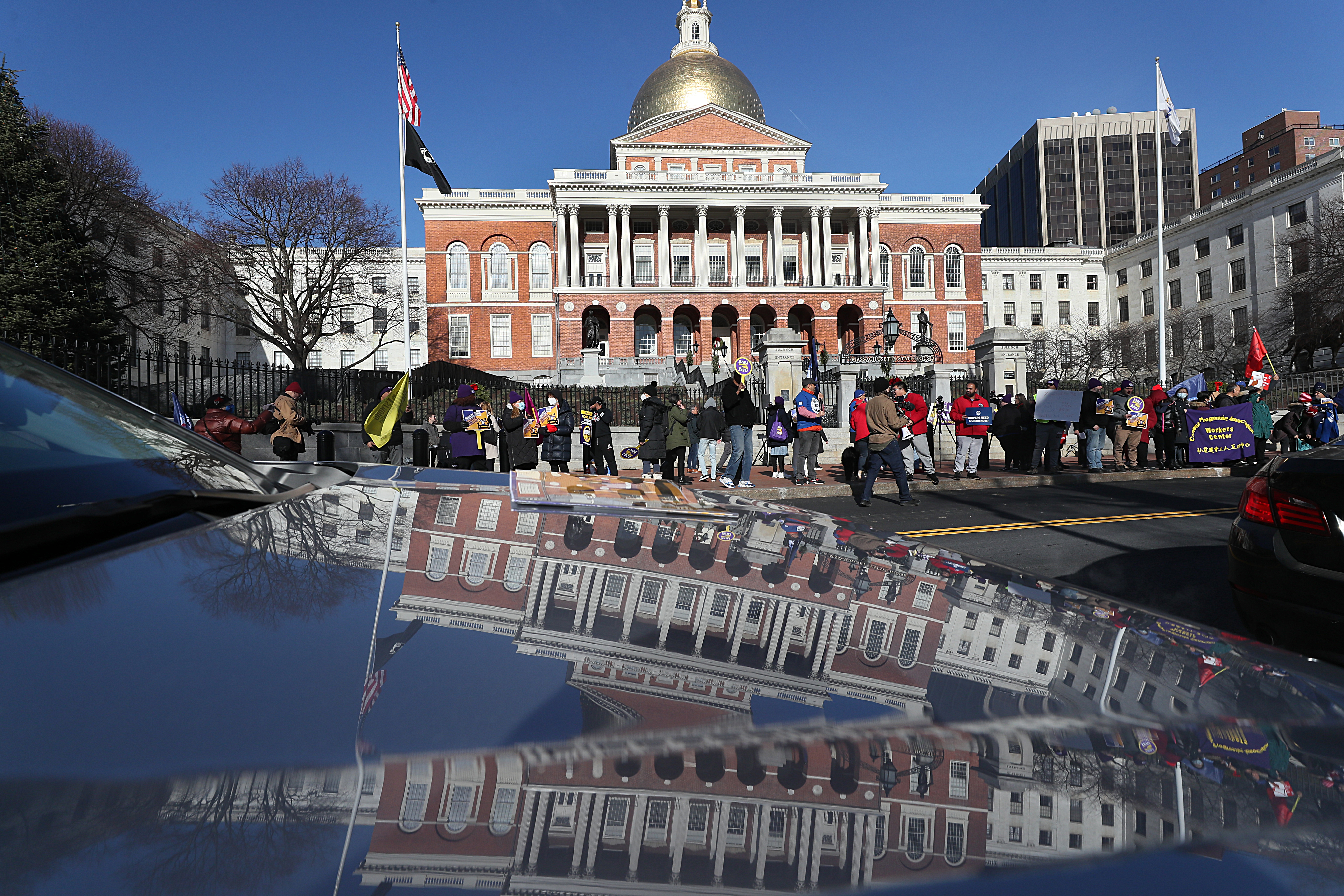 Ride hailing delivery drivers rally at the State House for higher