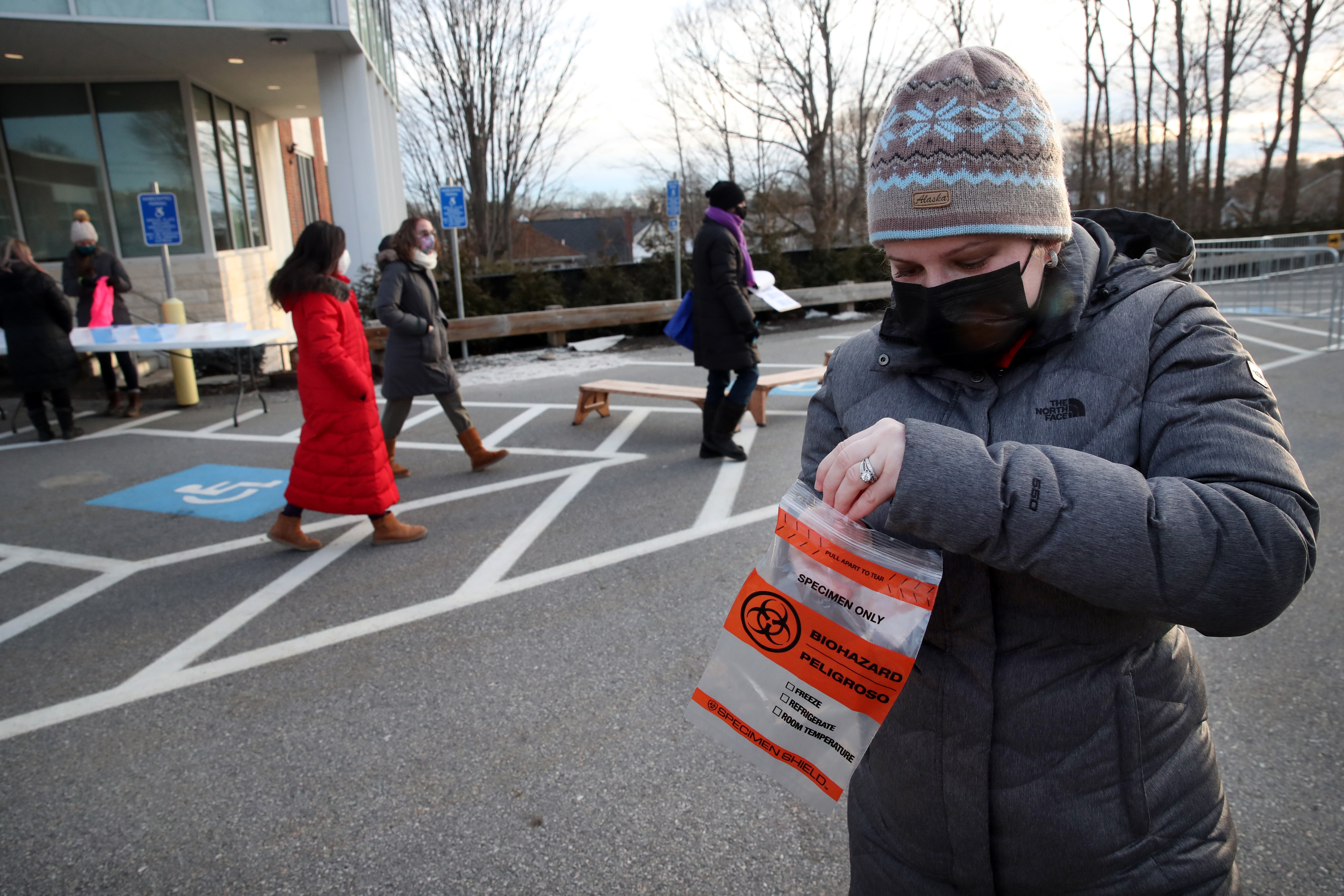 Teacher Michelle Voskov used a swab to collect a specimen when she arrived at work, at Temple Beth Shalom in Needham.