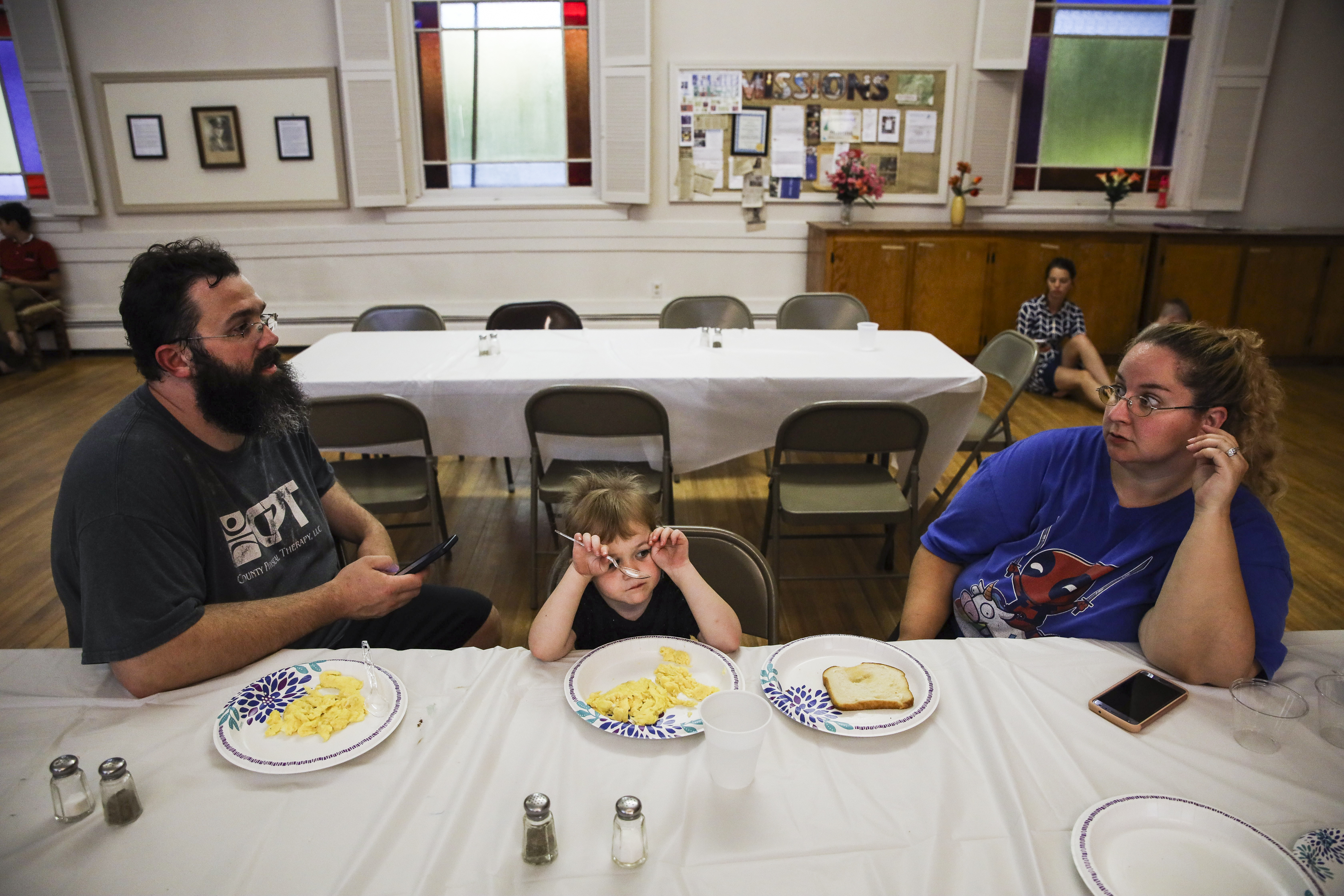 After arriving at the New Hampshire homeless shelter with an uncertain future, Patrick talks with Mariah while Laya eats dinner at the church. Shortly after the move, Patrick began applying for jobs. It was challenging to live within the strict rules and requirements of the program. They had been struggling on their own, but at least they had been in charge. “With homelessness, there’s an incredible amount of loss to deal with,” said Mariah. “It reaches far beyond a home and comforts of safety. There’s a loss of dignity, loss of confidence, loss of security.”