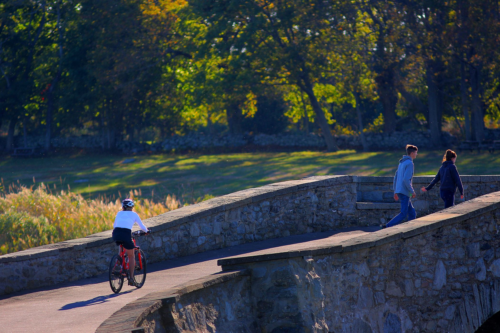 Park visitors crossed a small bridge over the Mill Gut shellfish management area at Colt State Park in Bristol, R.I.
