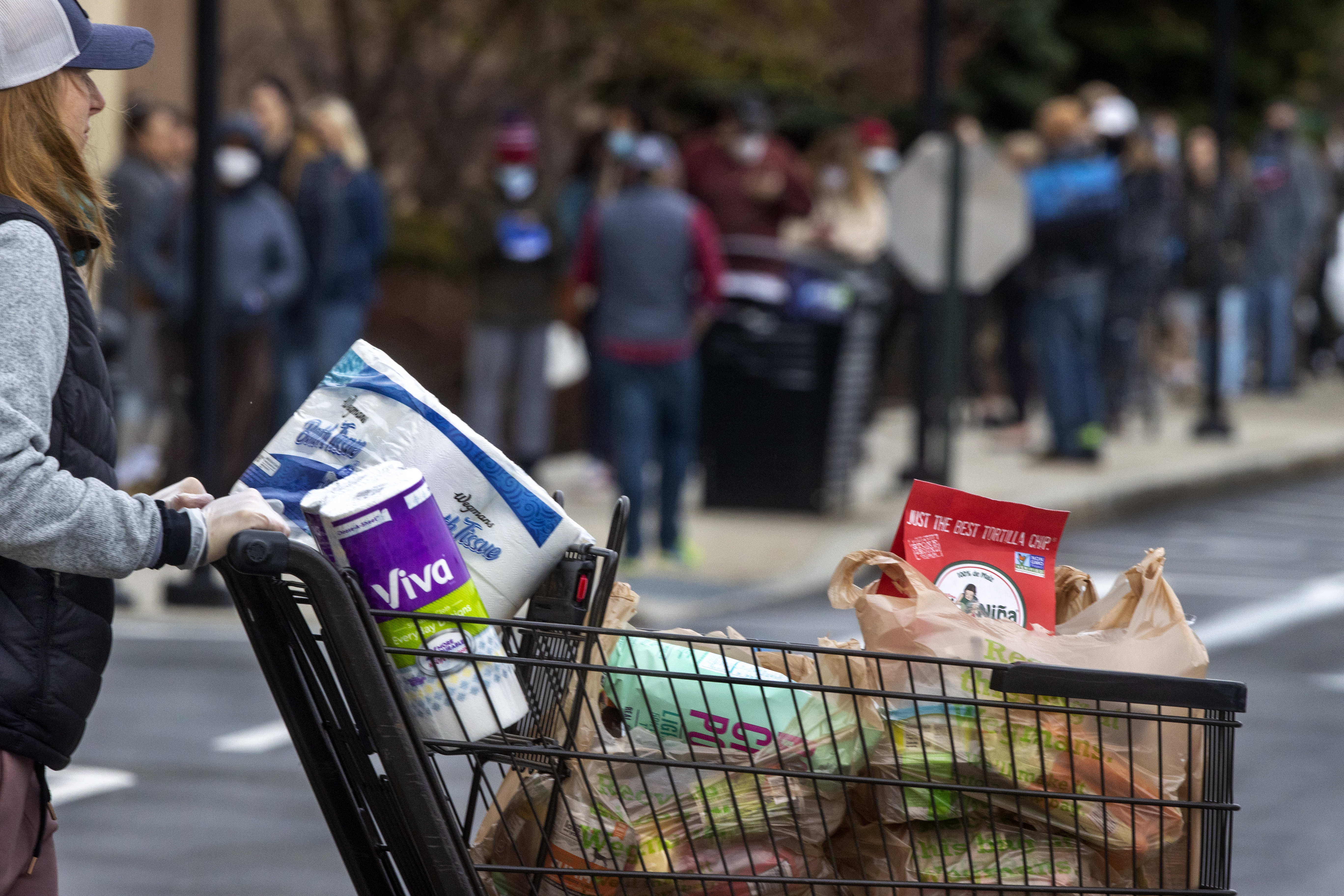 Medford, Ma- April 4, 2020 - Shoppers stand in line for an hour to get into Wegman’s as word spreads that they have toilet paper during the coronavirus emergency. (Stan Grossfeld/Globe Staff)