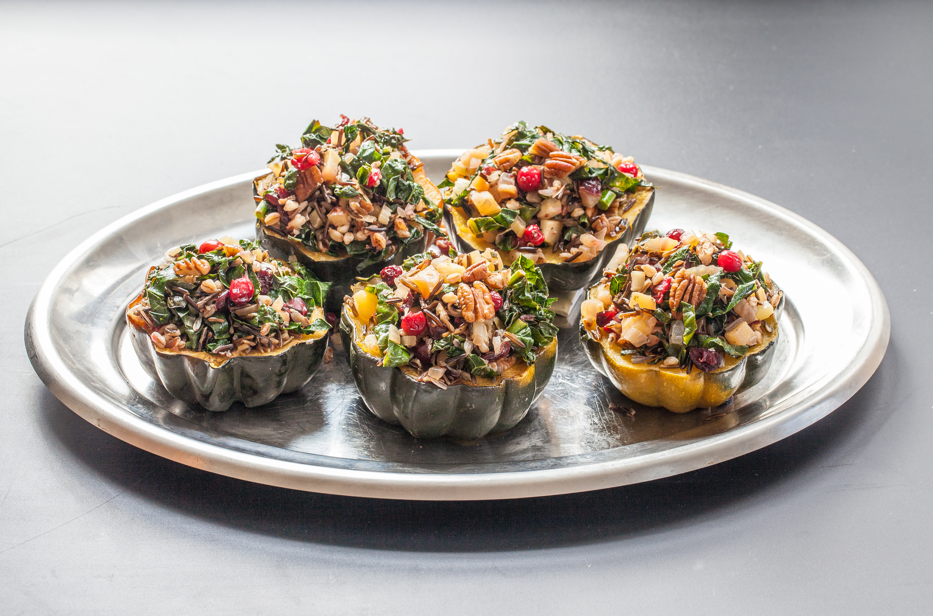 Stuffed acorn squash with wild rice, farro, and cranberries.