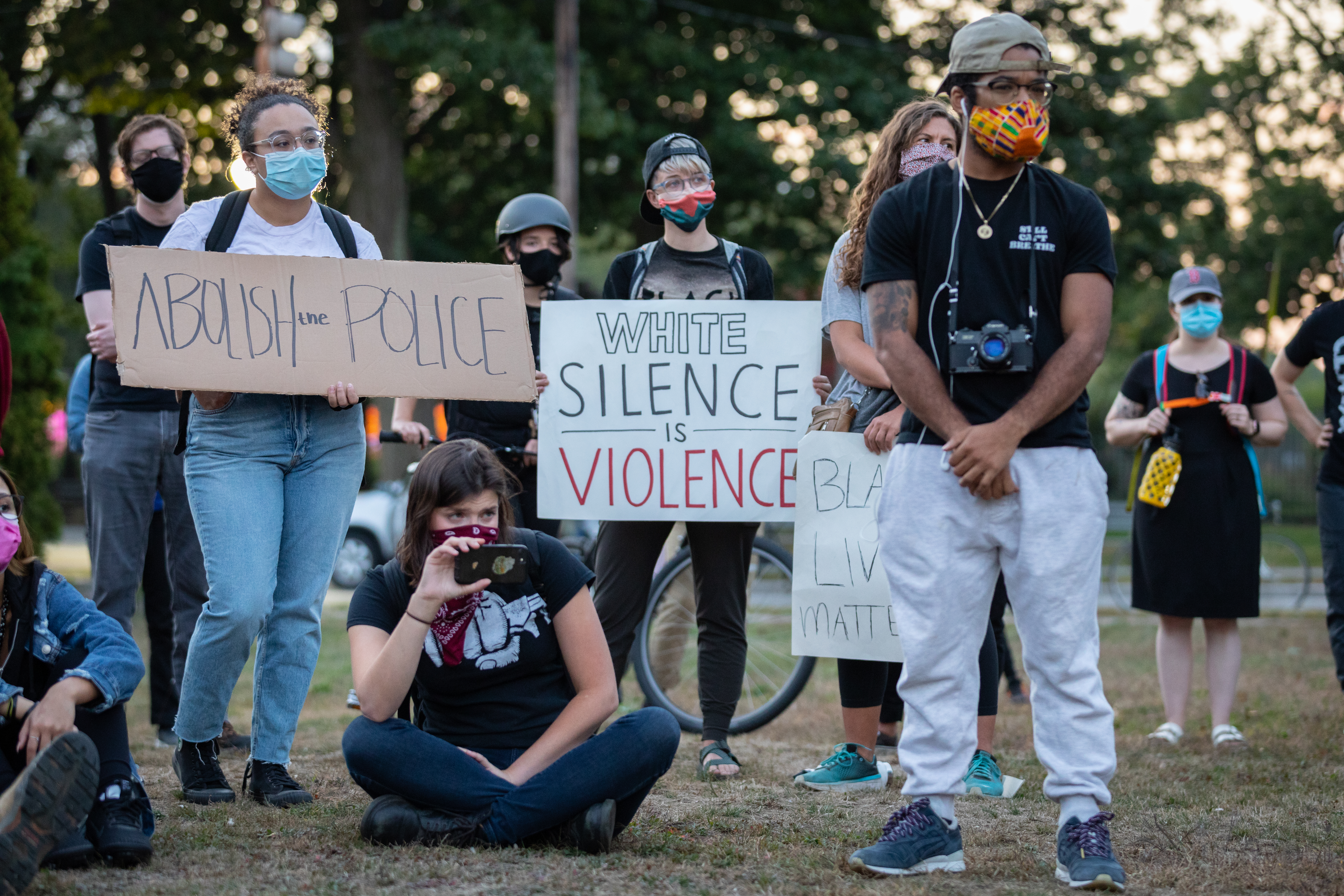 Attendees held signs while listening to speakers.