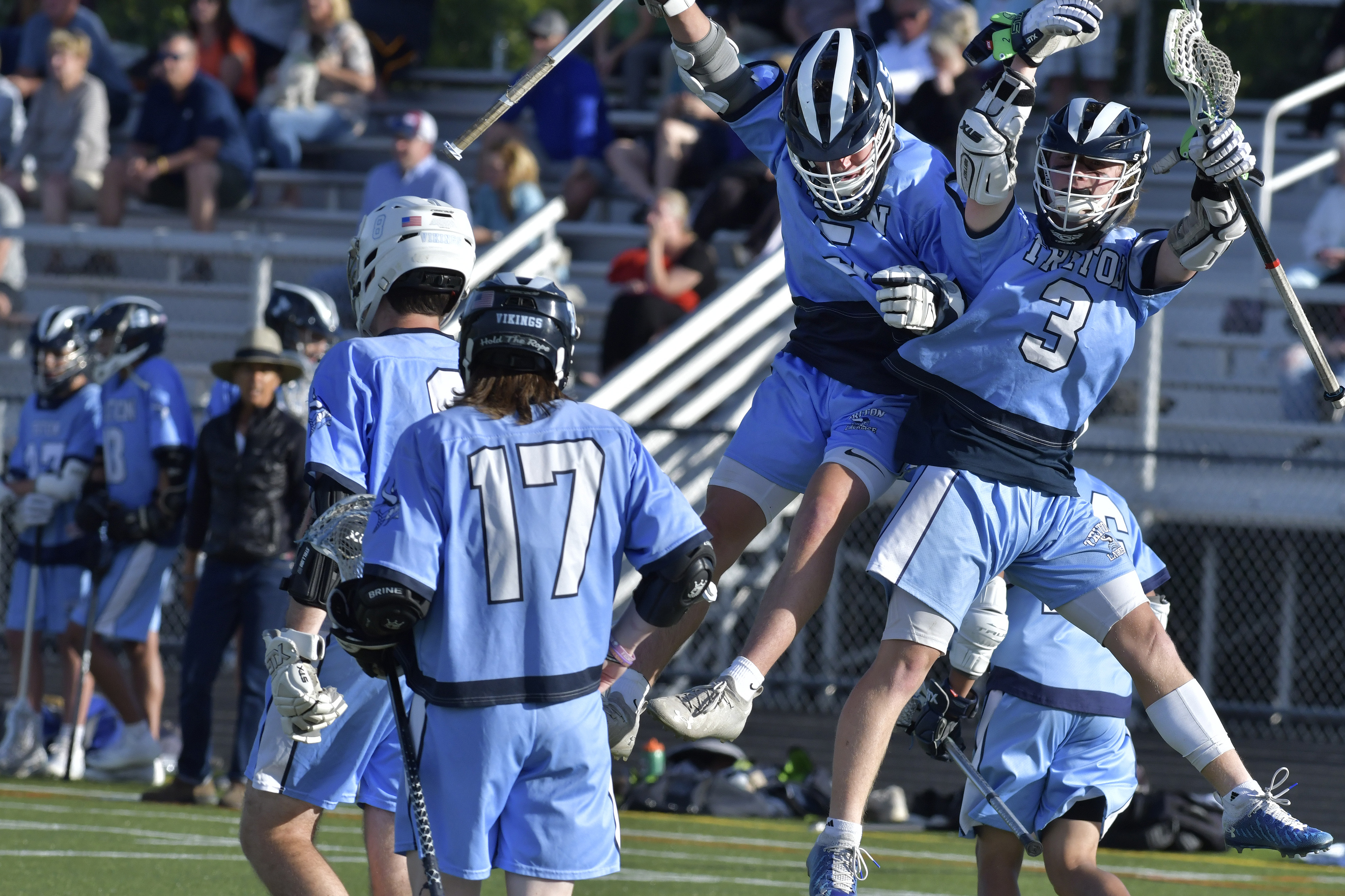 From left, Triton Regional's James Tatro, (5) and Jared Leonard (3) celebrated Leonard's goal in a 14-9 win over Cape Ann League rival Ipswich.