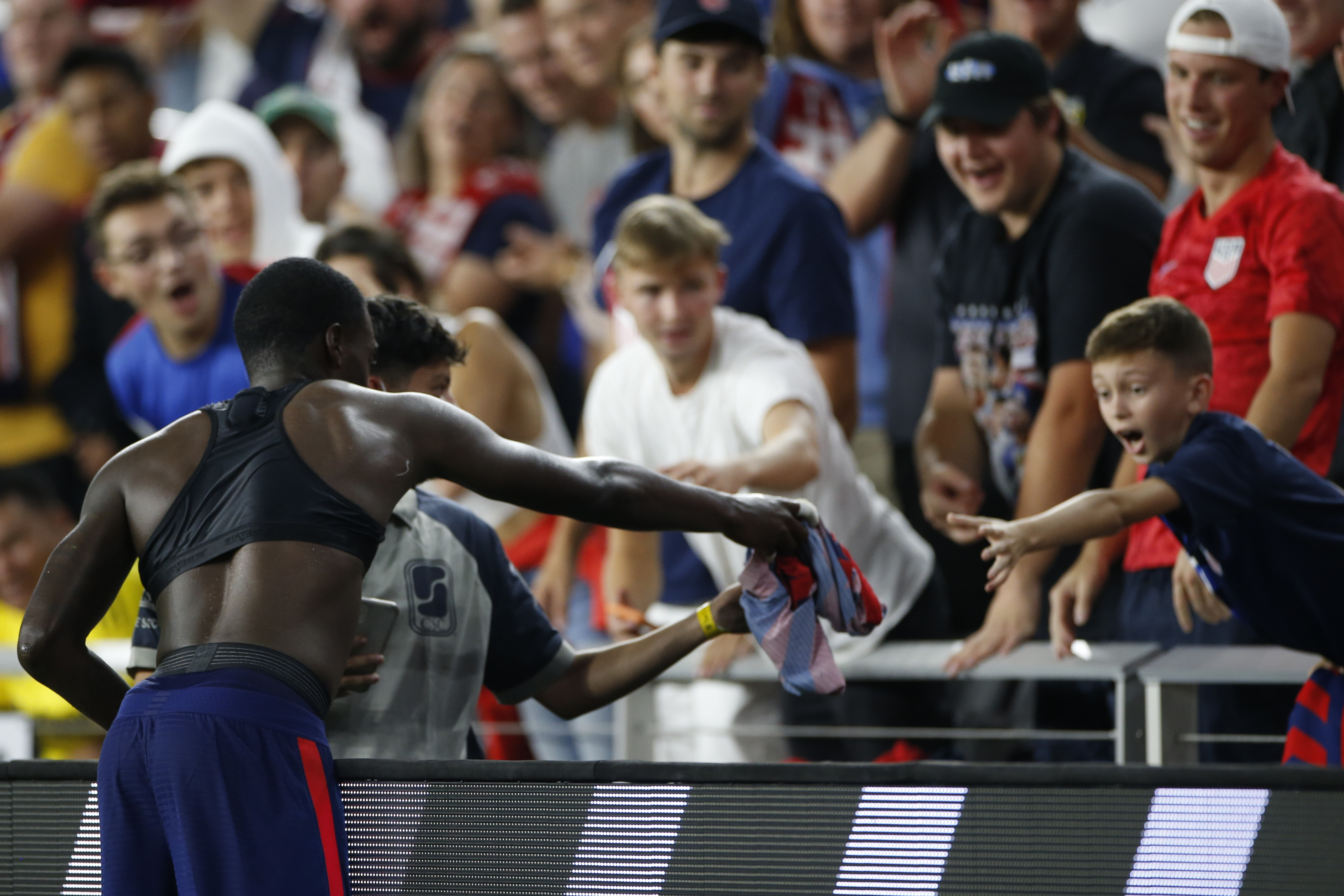 Tim Weah gives his jersey to a fan as he leaves Wednesday's World Cup qualifier against Costa Rica.