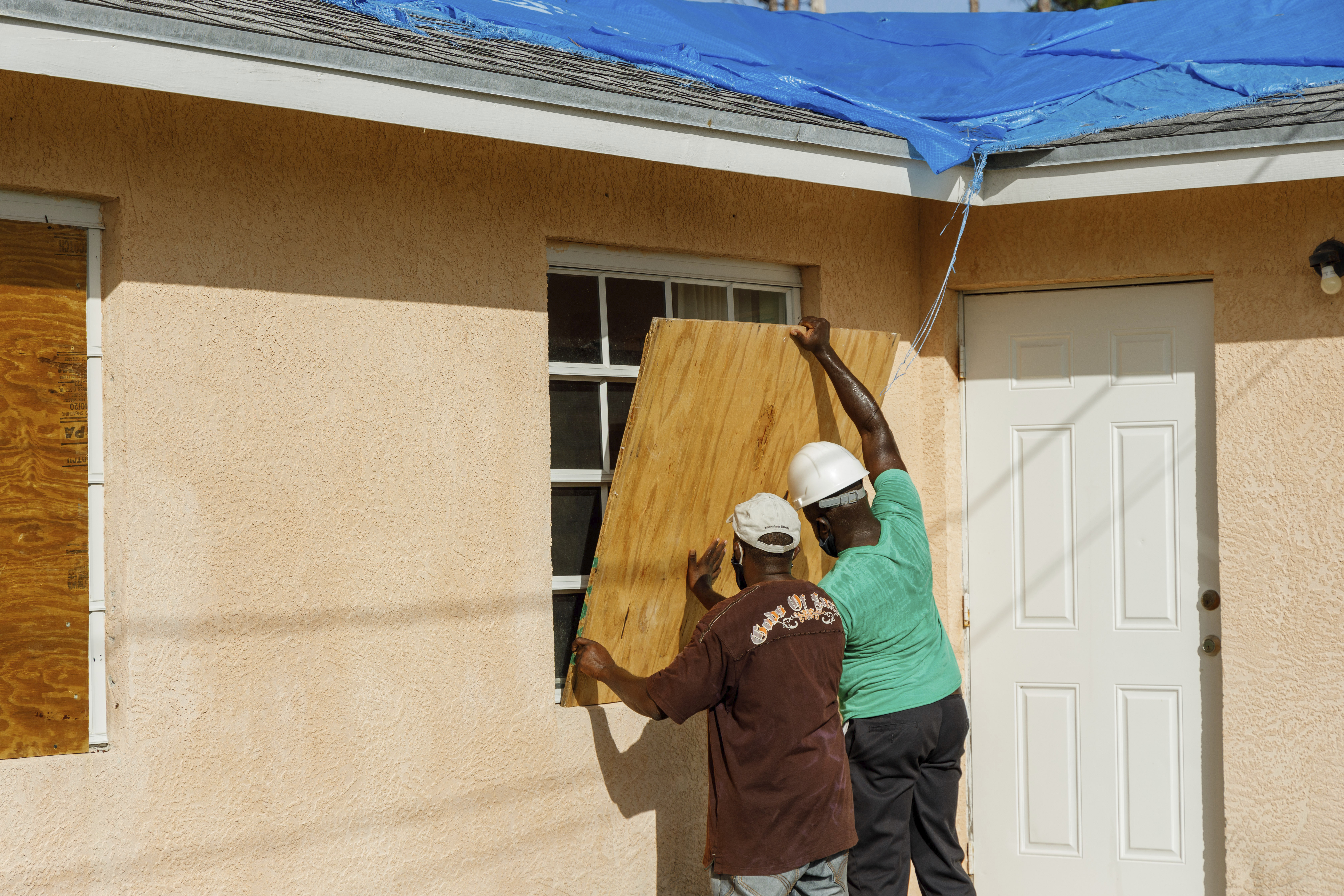 Residents covered a window with plywood in preparation for the arrival of Hurricane Isaias, in the Heritage neighborhood of Freeport, Grand Bahama, Bahamas, on Friday.