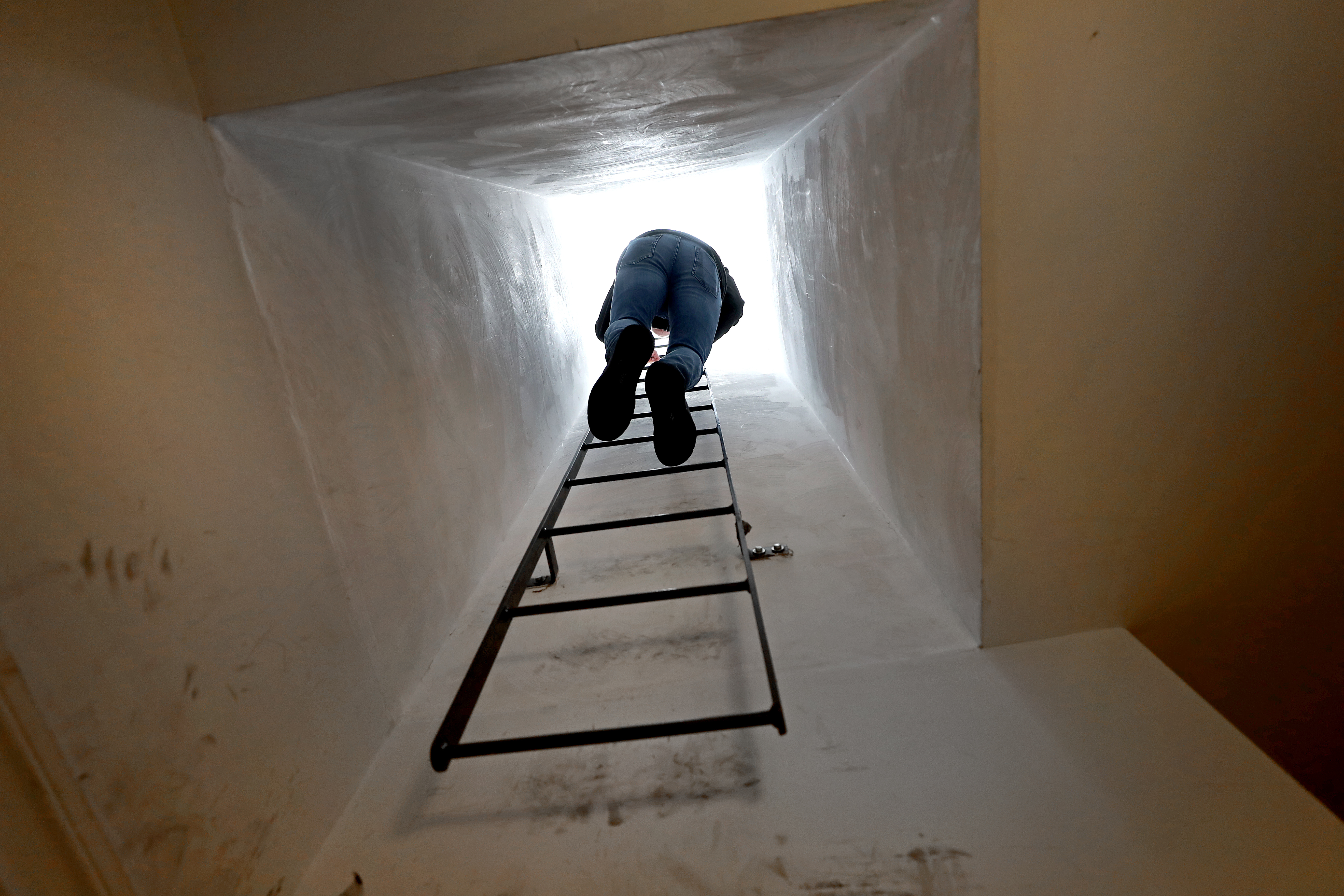 James Brock climbed a ladder up a narrow access space to the roof of a Boston property.