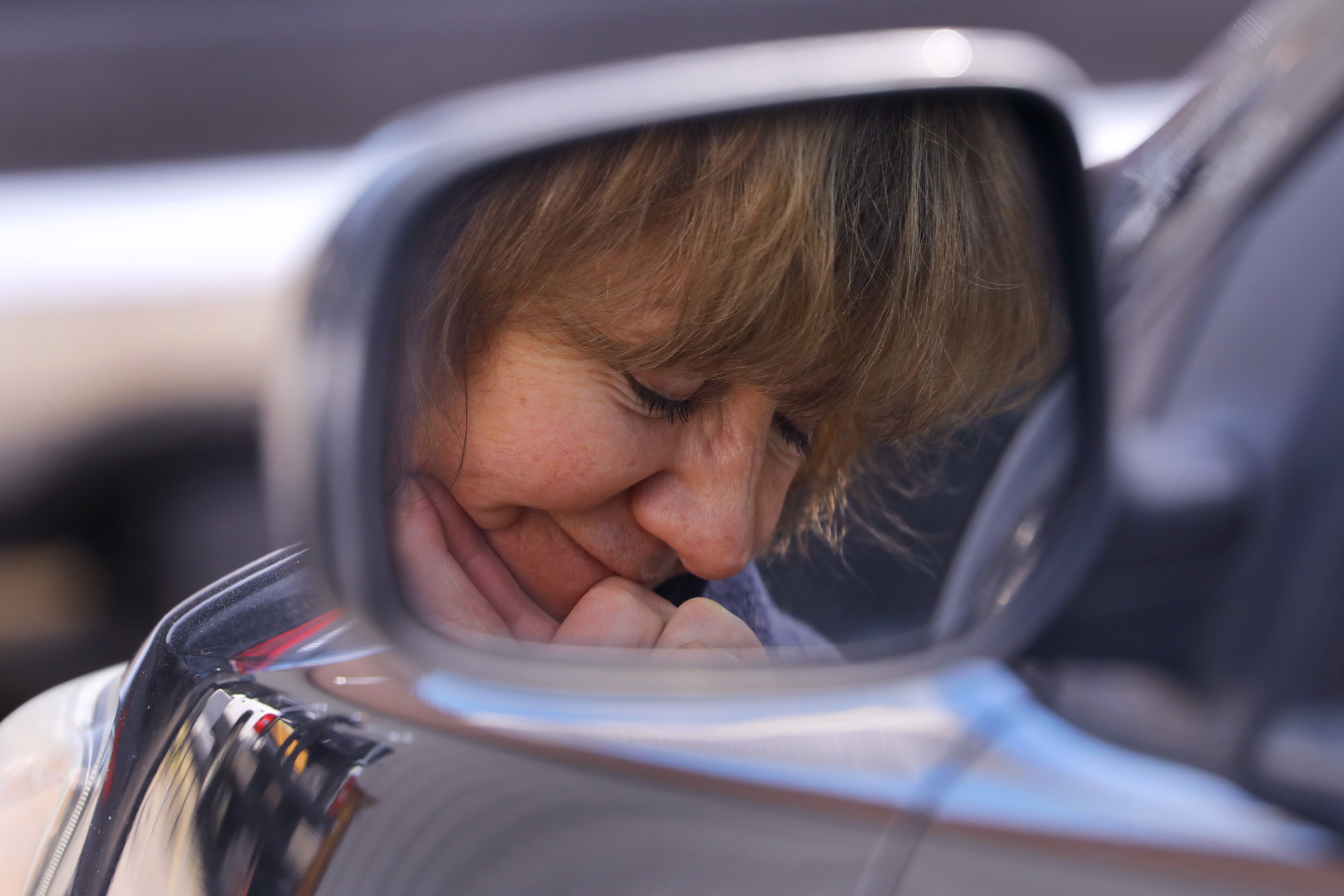 South Easton, MA 4/12/2020 A member for five years, Marcia Gardiner, bows her head during the pastor's prayer. Liberty Baptist Church, led by Pastor Adam Riveiro, holds a drive-in Easter service, in the South Easton church's parking lot. The unusual service is because of the coronavirus/COVID-19 pandemic. (Pat Greenhouse/Globe Staff)