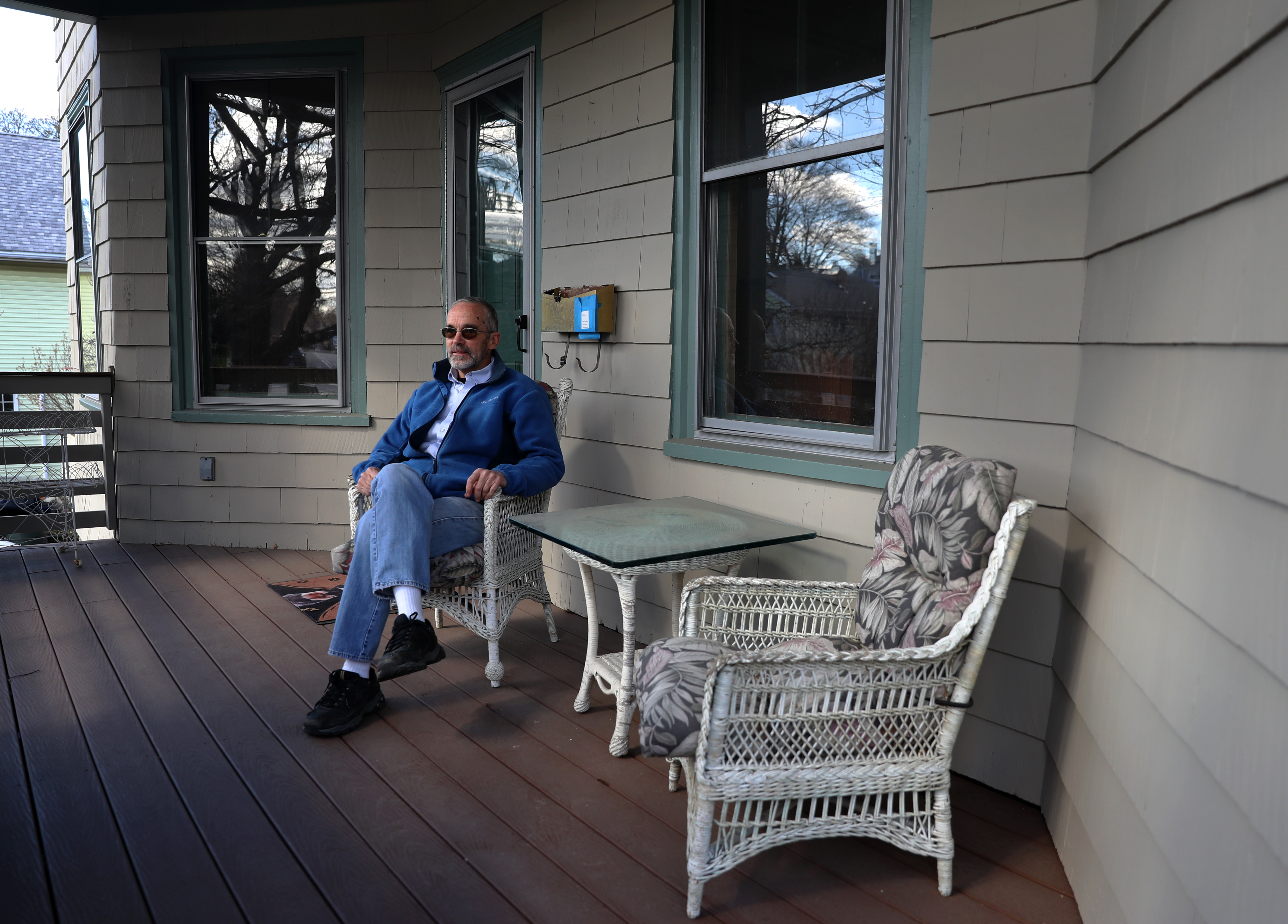 CAMBRIDGE, MA - 4/07/2021:FOR ADDRESS COVER STORY...... Paul E. Fallon sits on his front porch, a homeowner hopes to bring more diversity and affordable housing to Cambridge by bequeathing his multifamily home to a nonprofit instead of his children. He's hoping that others will follow suit. (David L Ryan/Globe Staff ) SECTION:ADDRESS