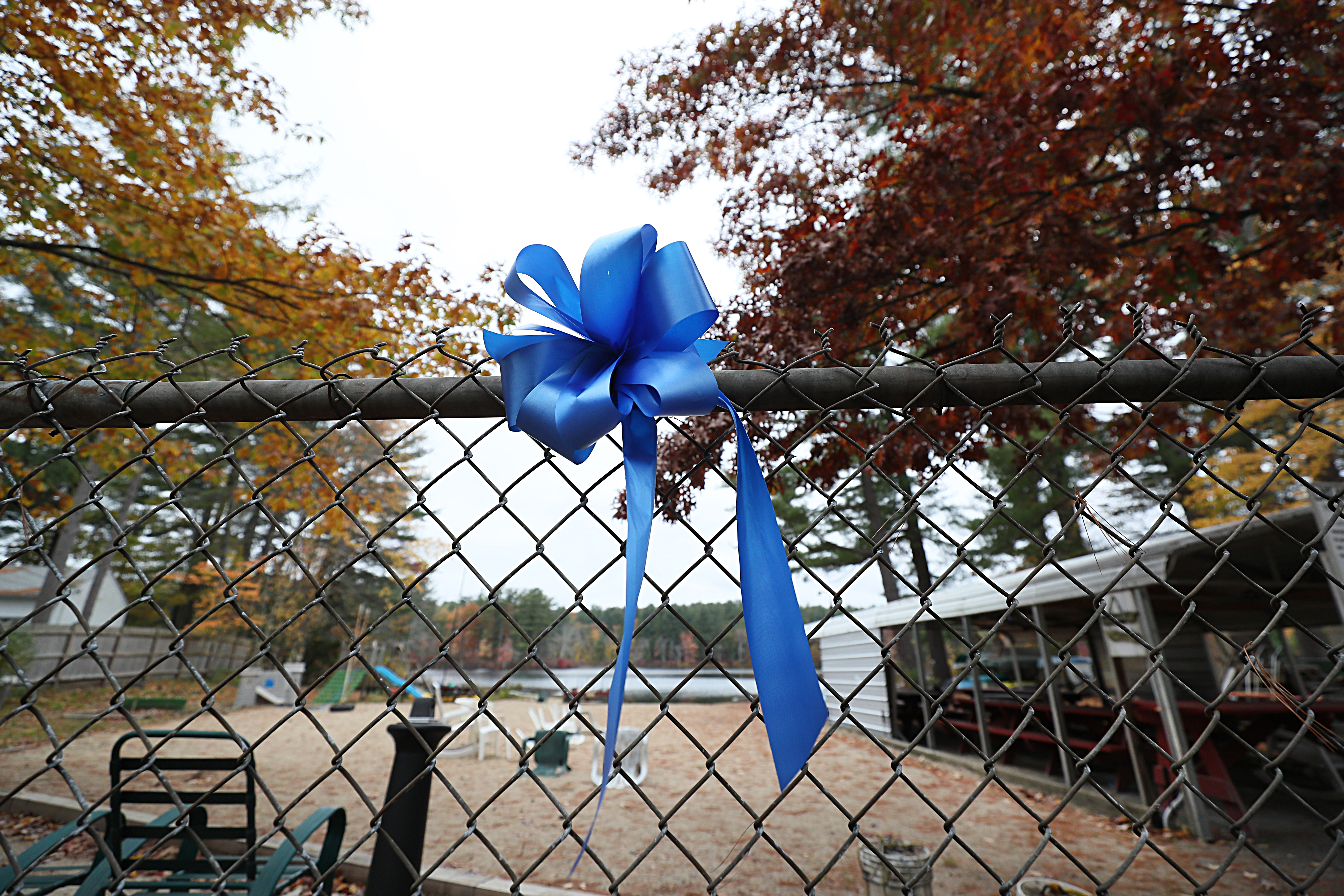 A blue ribbon was placed on a fence at the neighborhood beach next to the Elijah Lewis's home at 7 Sunset Drive in Merrimack, N.H.