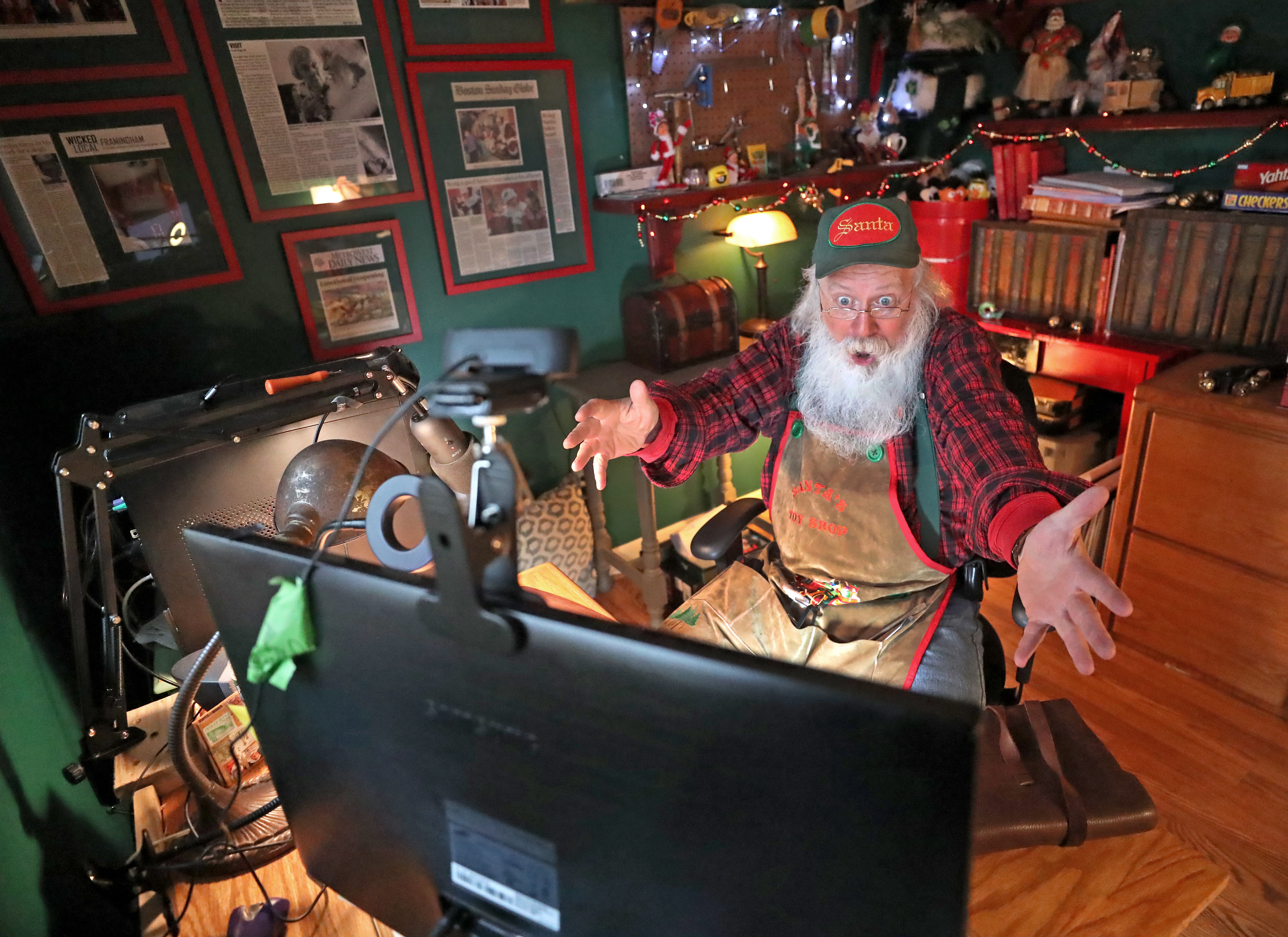 Santa Bob sits by a computer in his Santa office where he is making Zoom calls with children this year. It's one of many changes that Santas are facing amidst the coronavirus pandemic.