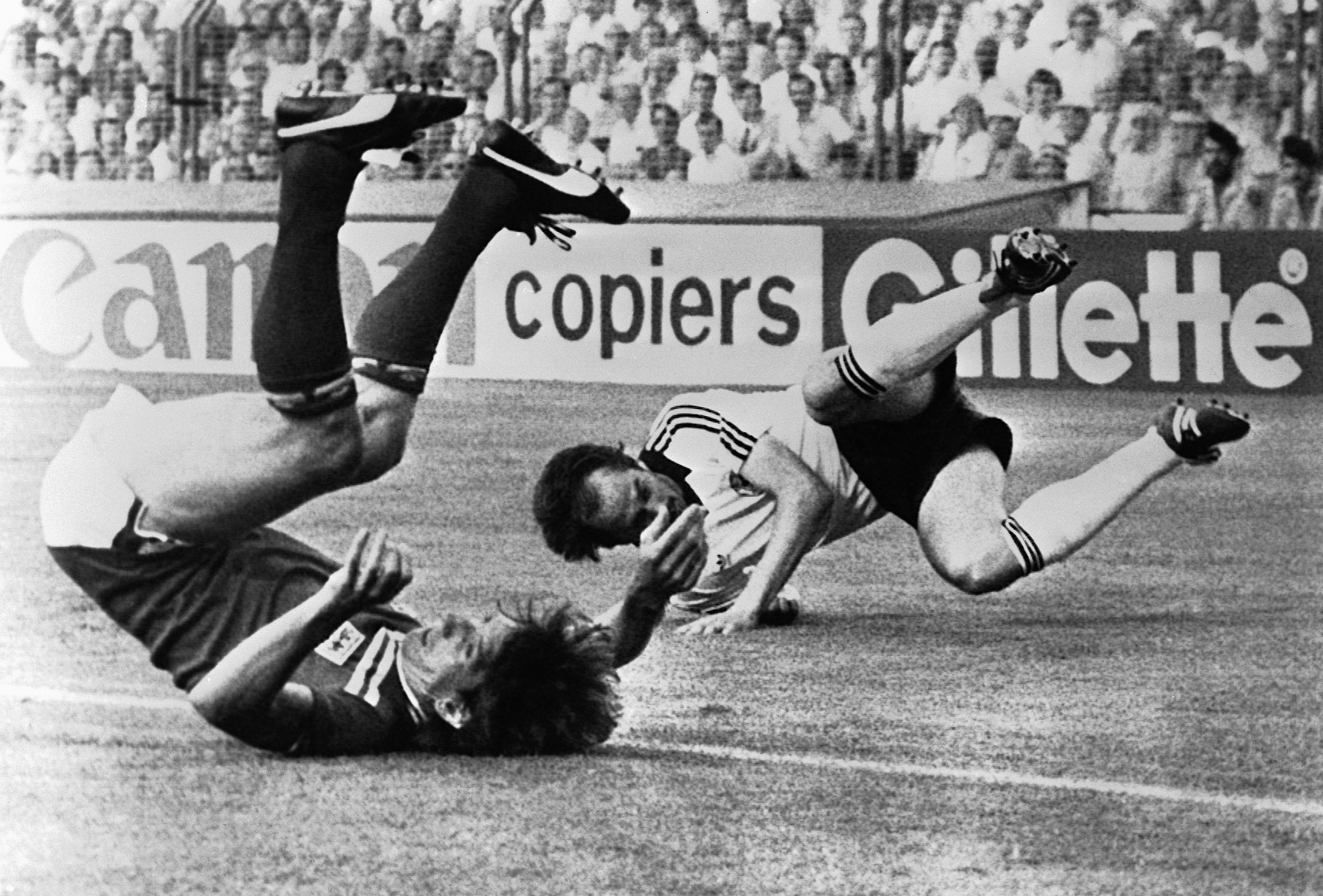 Mr. Mariner (left) crashed to the ground after colliding with West Germany's Uli Stielike during a World Cup match in 1982.