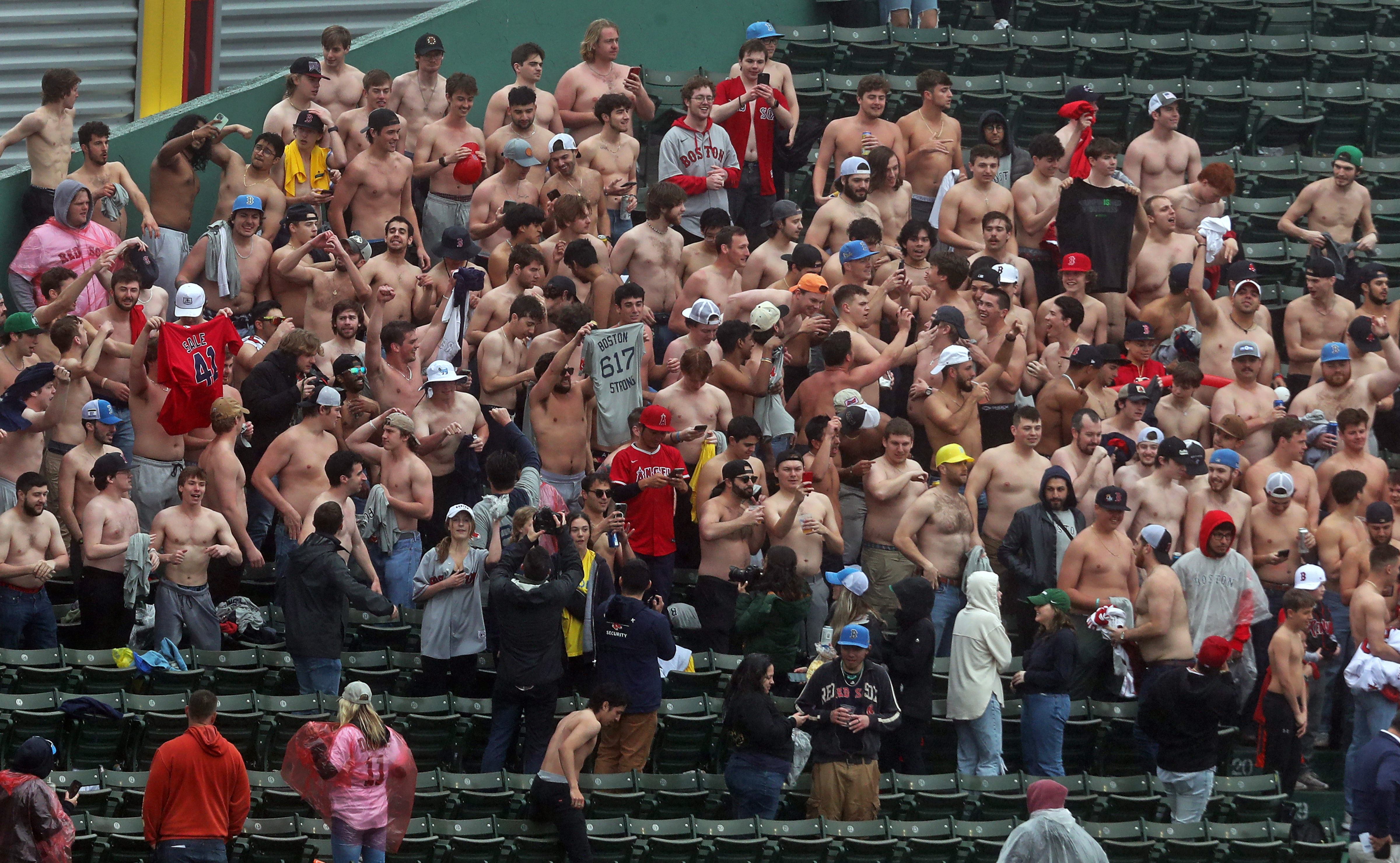 Red Sox fans go shirtless during lengthy rain delay at Fenway