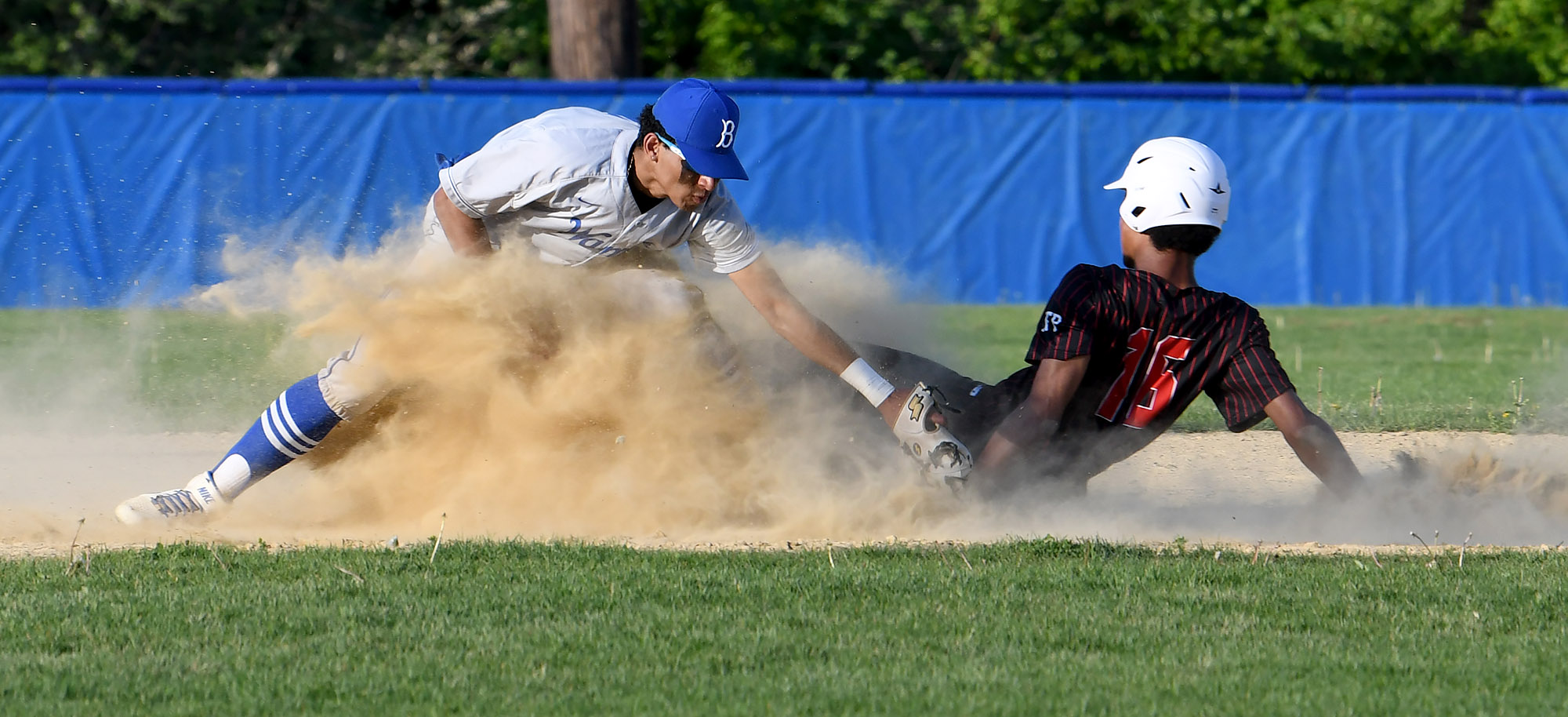 Milton's Marcus Olivierre slides into second as Braintree shortstop Jordan Gorham can't get the tag down in time.