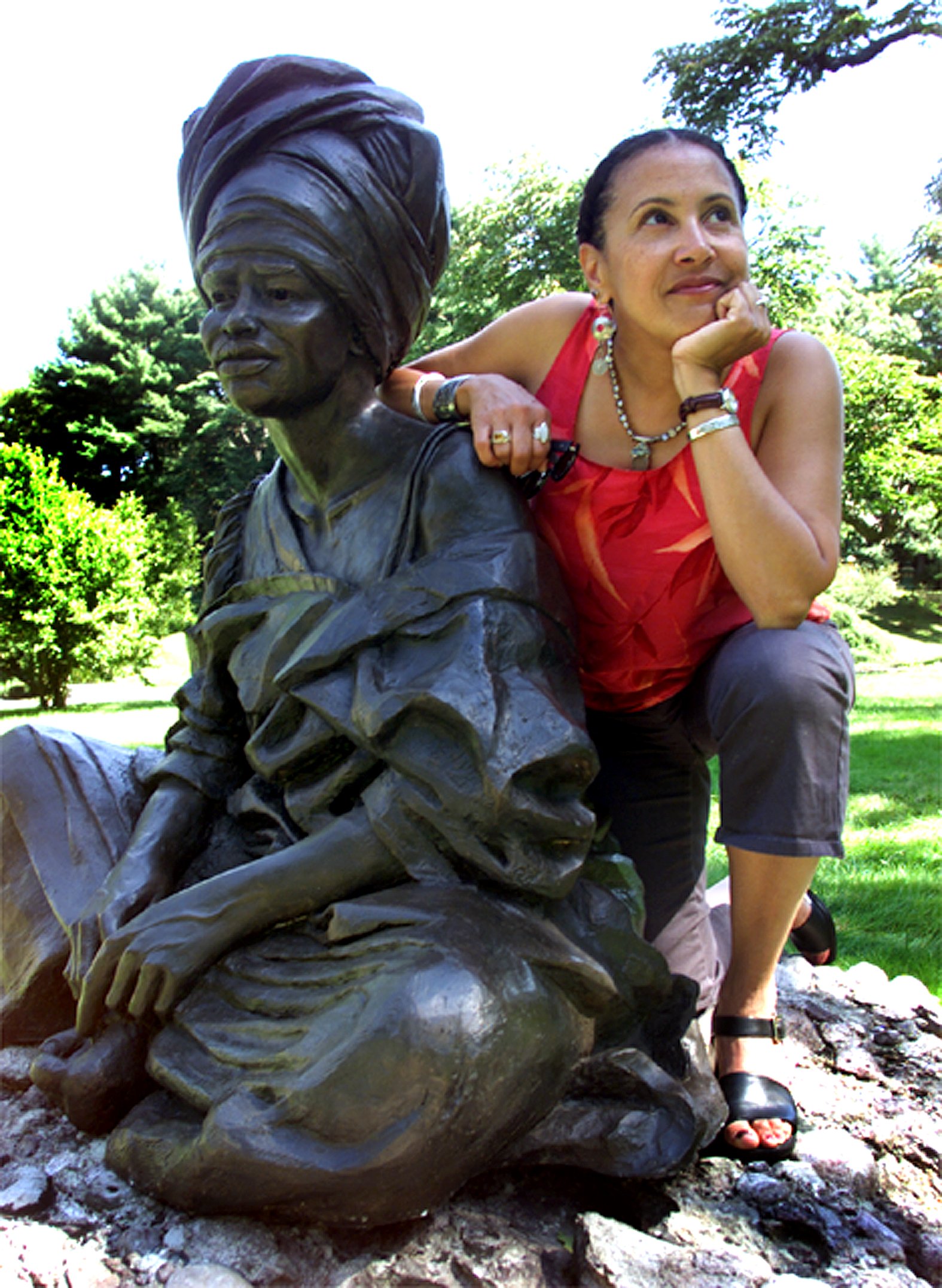 Ms. Cunningham-Terry, with her sculpture "The Sentinel," on the sculpture path at Forest Hills Cemetery.