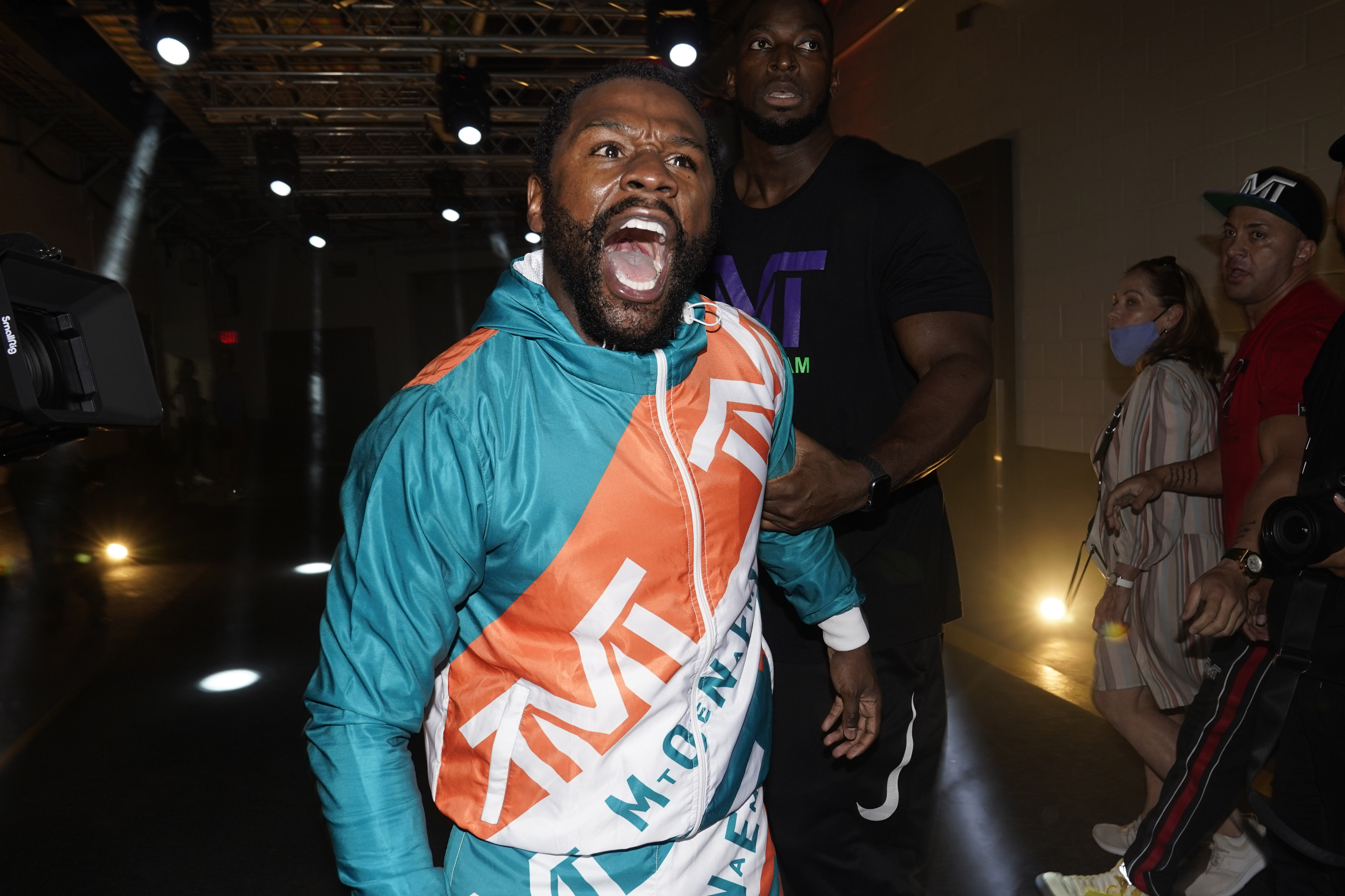 Floyd Mayweather yells at challenger Logan Paul after a scuffle broke out that involved Paul's brother Jake Paul, during a press conference Thursday.