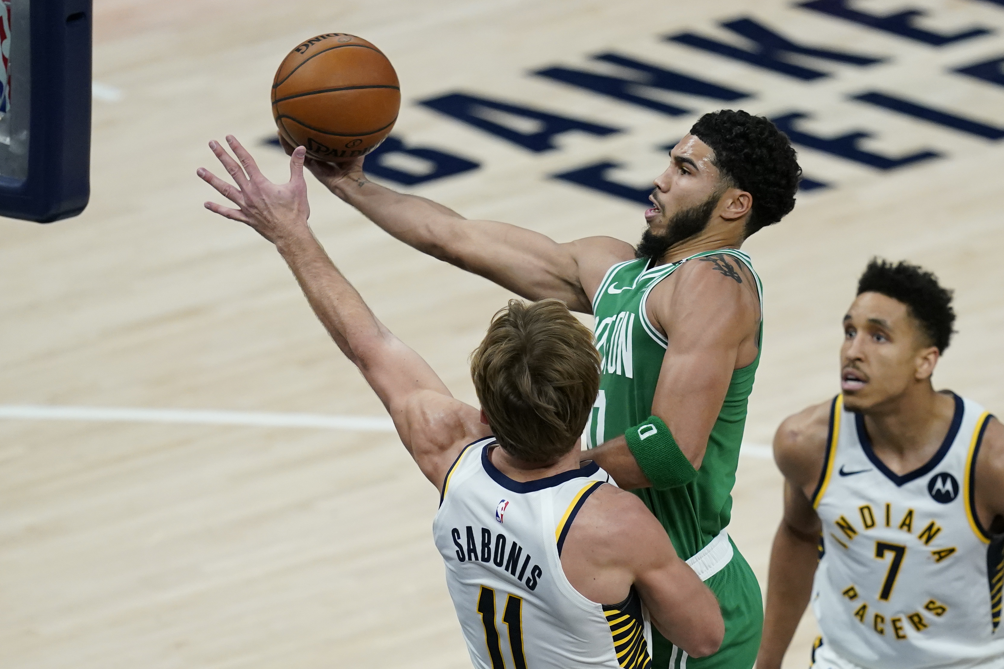 Jayson Tatum puts up a shot against Indiana's Domantas Sabonis during the first half of Tuesday's game.