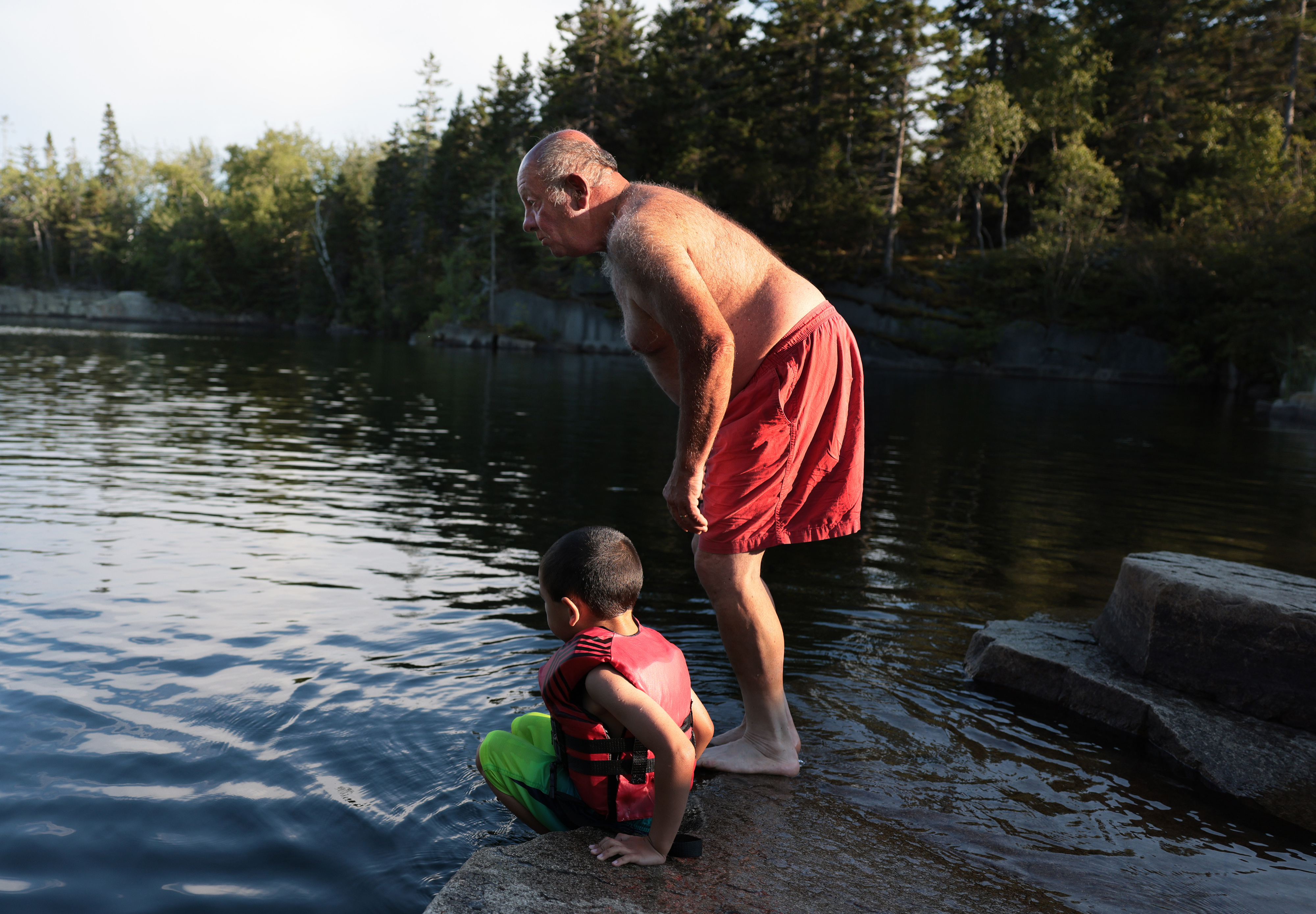 John Bickford, a lobsterman on the island, swam with his 5-year-old son, Michael, at Booth’s Quarry on Vinalhaven on July 23. 
